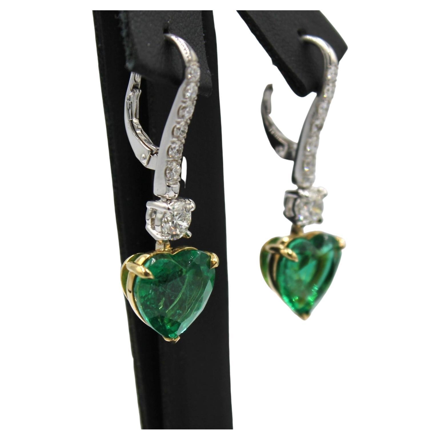 8.79 carats Paired Heart-shaped Zambian Emerald with fourteen round Diamonds totaling the weight of 1.26 carats. 

This piece will highlight your elegance and uniqueness. 

*Lab Certificate is available upon request*

Item Details:
- Type: Earring
-
