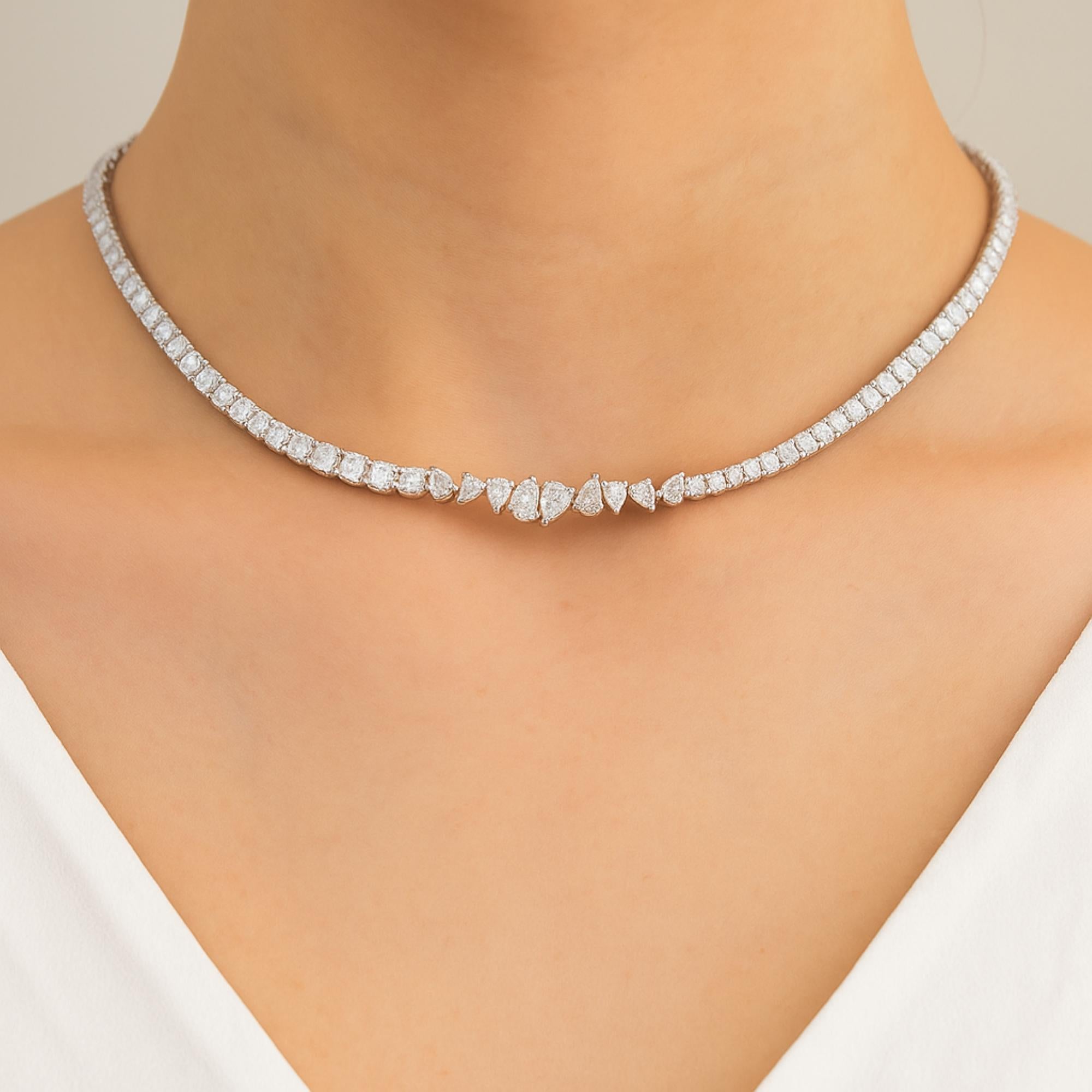 This SI/H Natural 8.7 Ct Diamond 18 Karat White Gold Chain Necklace is a modern and refined take on the classic tennis style. At the center, the design features a cluster of mixed shape diamonds arranged in a graduated pattern. 
Diamonds are a