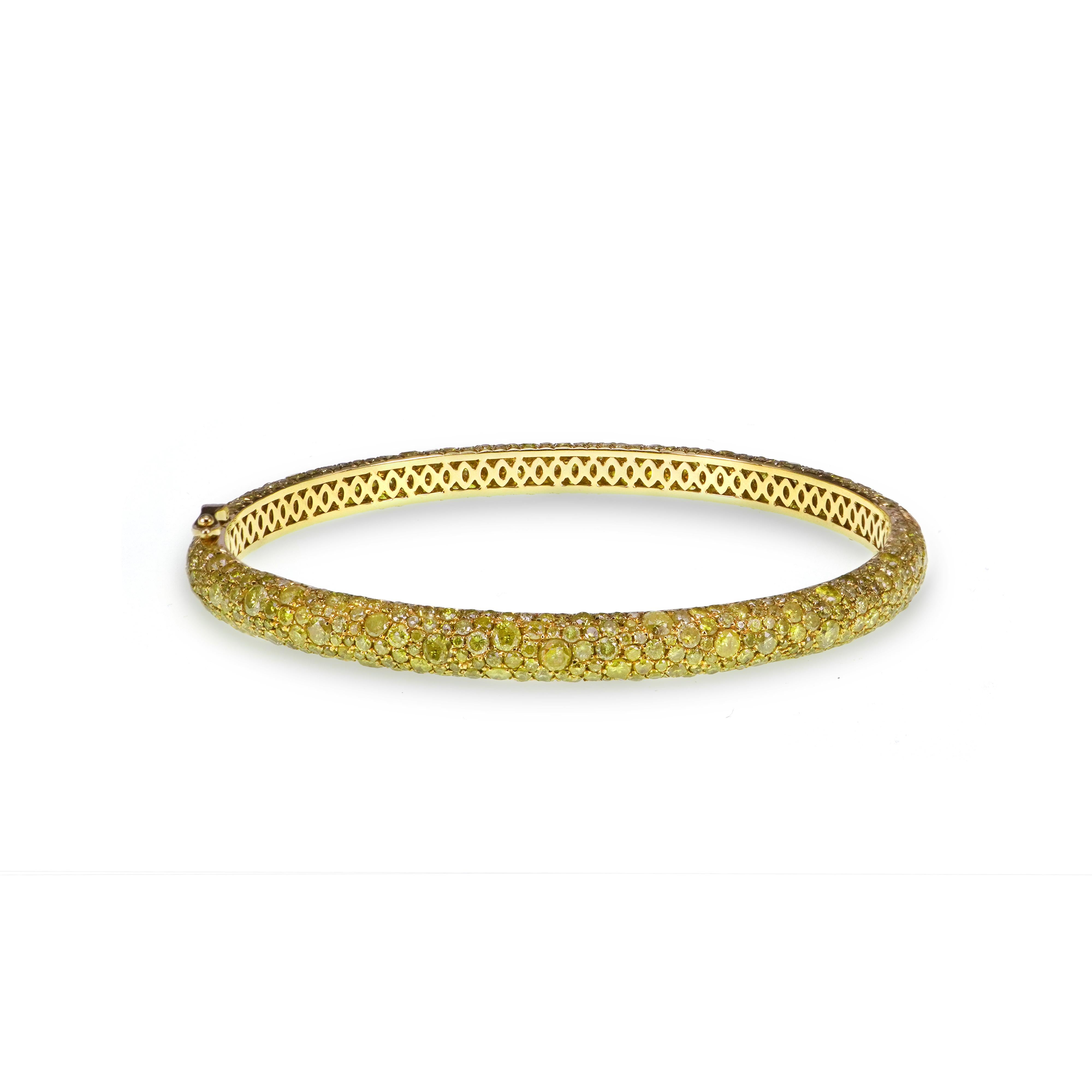 Ever glowing 8.82 carats of fancy vivid yellow diamond in round brilliant are used to make this classical eternity bangle. 
The bangle sits beautifully on the wrist and can be seen in the images attached with the listing
