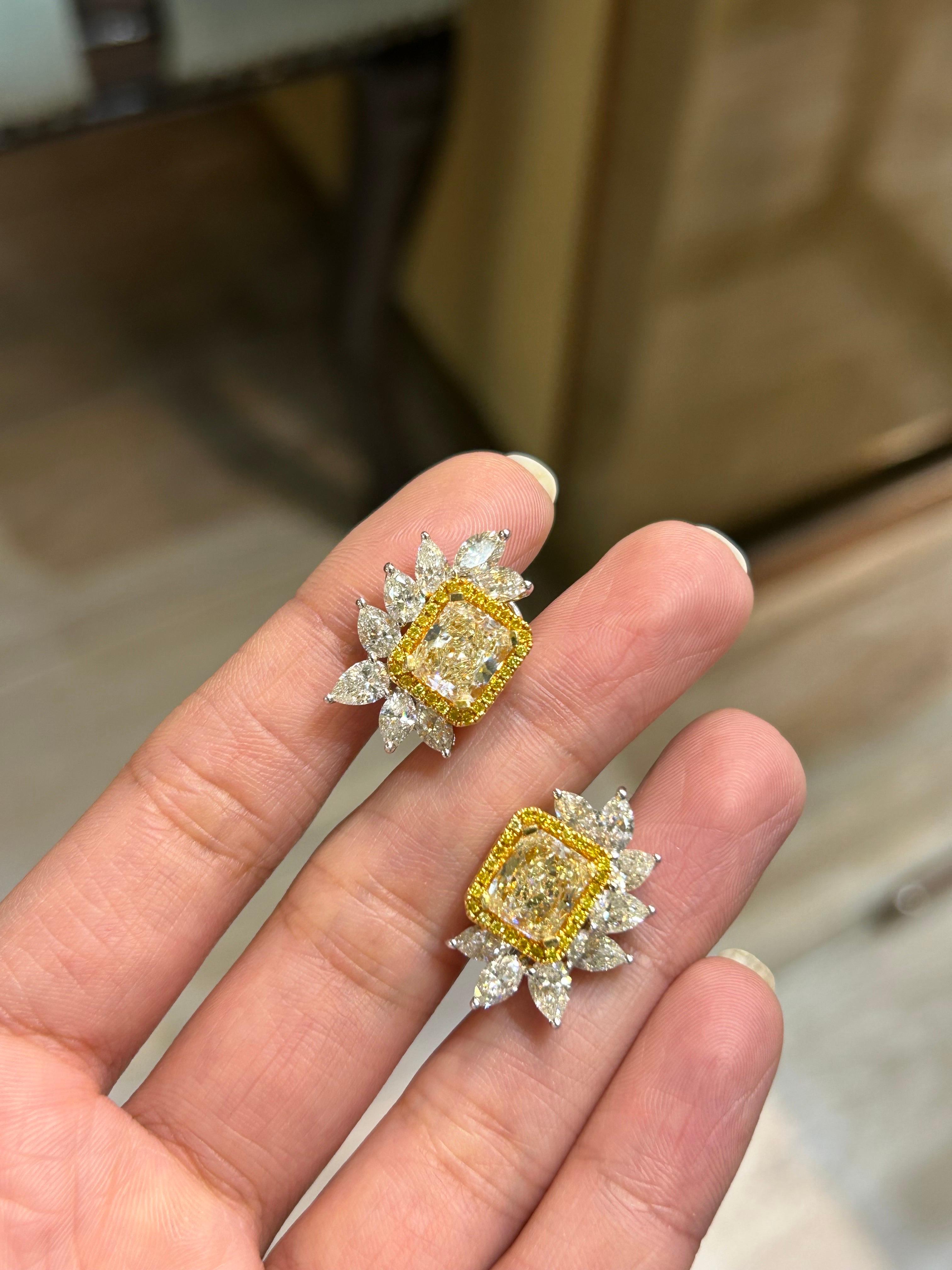 Make a statement with these 2.05 carat and 2.01 carat YZ color VVS/VS quality radiant cuts, with 0.39 carat yellow diamonds, 1.78 carat marquise diamonds, and 2.60 carat pear shape diamonds. Comes with an omega, lever backing. All set in 18K gold. 