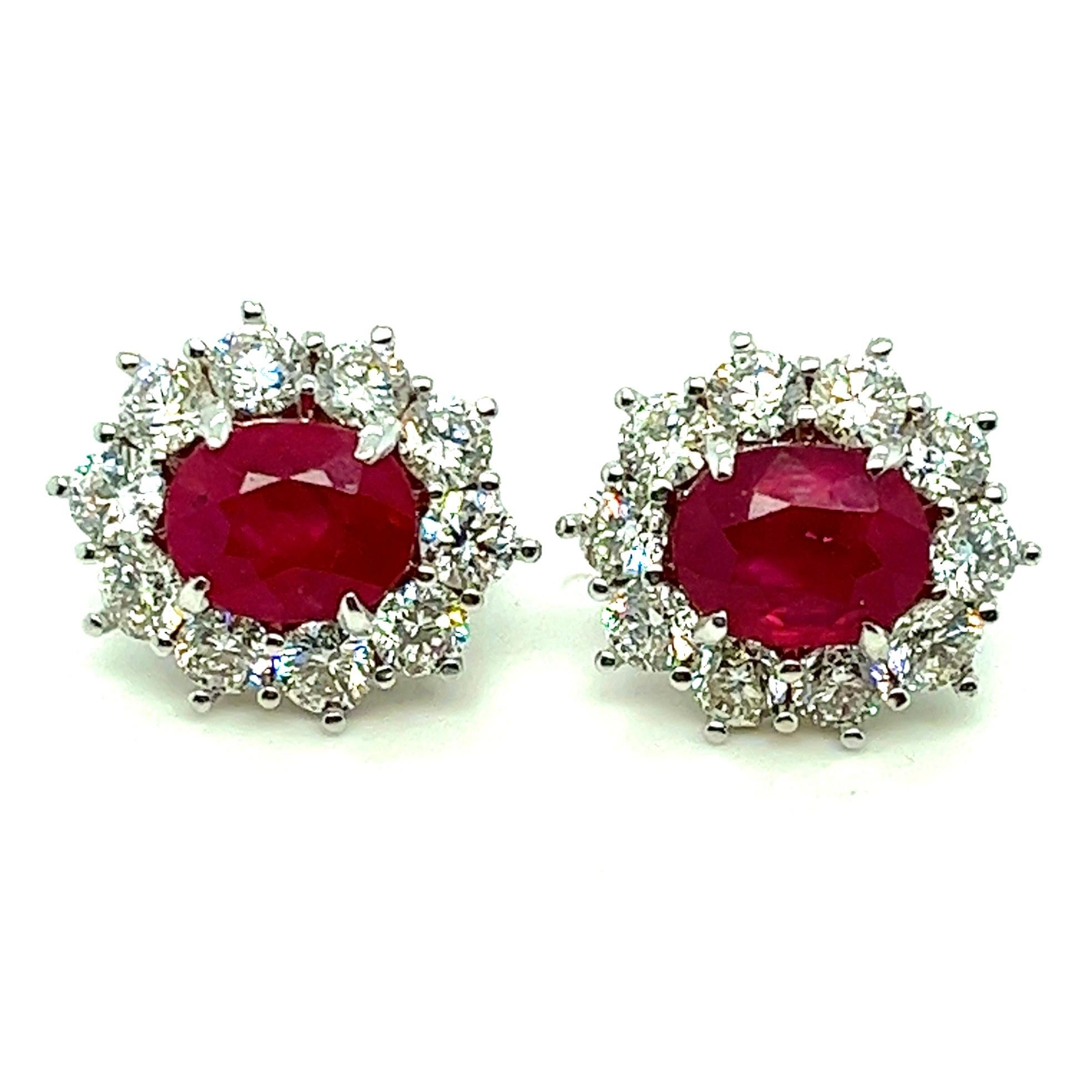 Offered here is a perfectly matched pair of natural earth mined Ruby Diamond Earrings in 18kt gold.
Diamonds: 20 natural round brilliant cut diamonds with an estimated total weight of 3.67 ct. Clarity is VS-SI & Color is G-H. 
Ruby: 2 natural Oval