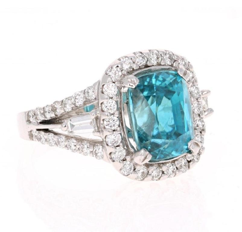 
A Dazzling Blue Zircon and Diamond Ring! Blue Zircon is a natural stone mined in different parts of the world, mainly Sri Lanka, Myanmar, and Australia. 

This Cushion Cut Blue Zircon is 7.70 Carats and is surrounded by a halo and split shank of 50