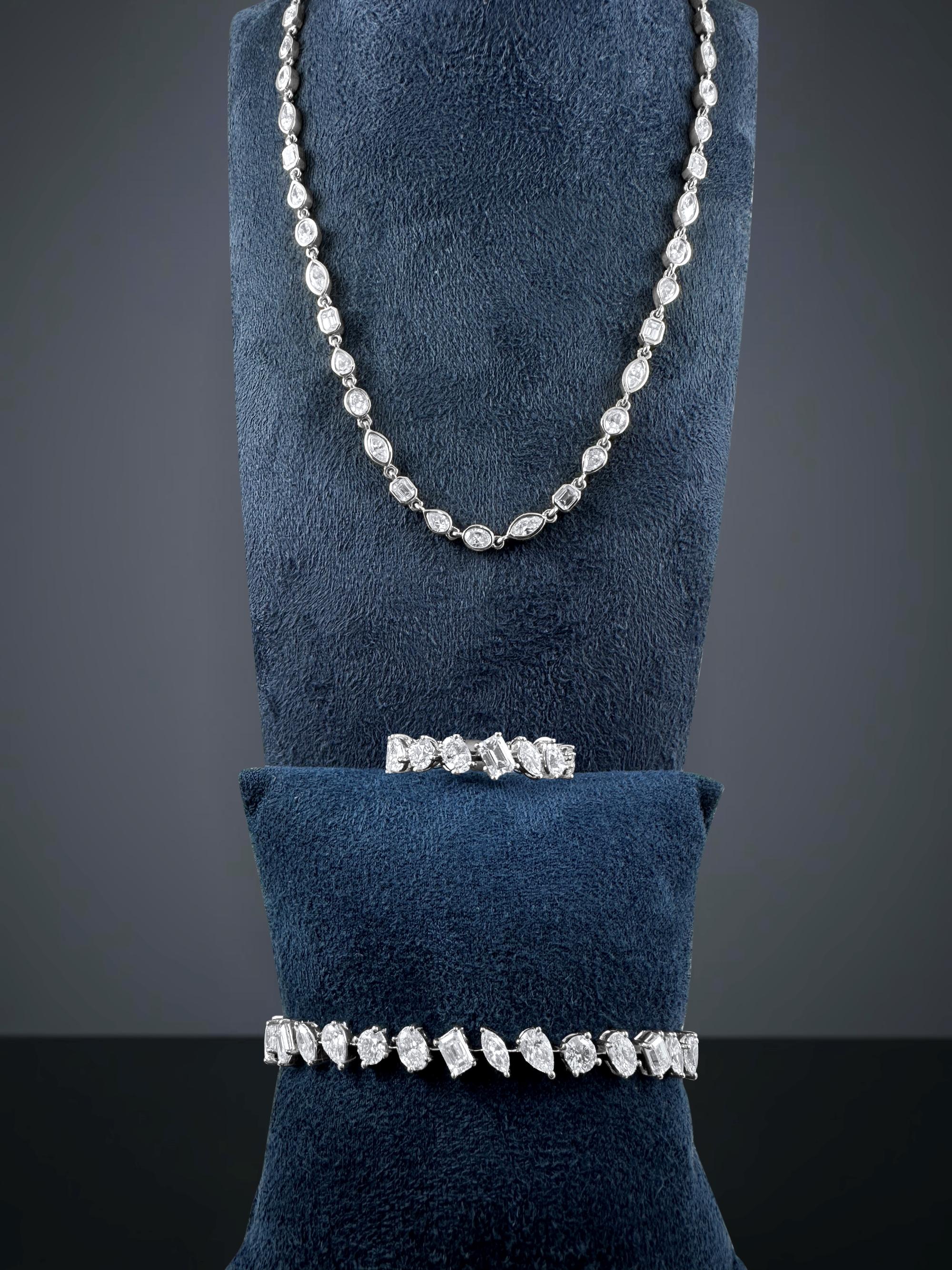 A refined expression of modern artistry, this 8.85-carat diamond tennis necklace features an elegant mix of emerald-cut, oval, pear, marquise, and round brilliant diamonds, each meticulously bezel-set in polished 14K white gold. The alternating