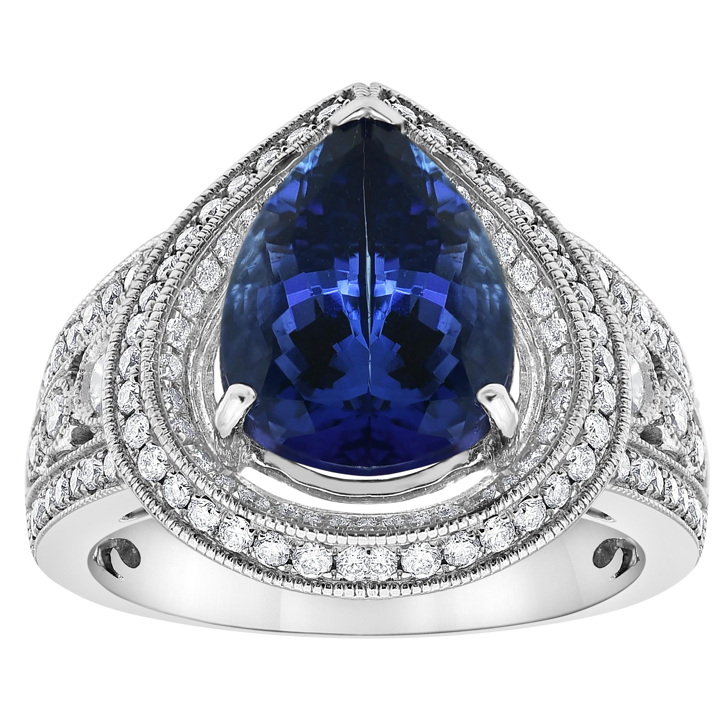 Complement her evening looks with this alluring fashion ring. Crafted in 14K White Gold, this style features an 8.85 Carat Pear-cut bright blue Tanzanite wrapped in a frame of shimmering 1.15 Carat Diamonds Color with H-I, Clarity SI1-I1. Buffed to