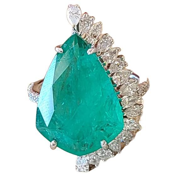A very beautiful Emerald Cocktail Ring set in 18K Gold & Diamonds. The weight of the shield shaped Emerald is 8.85 carats. The Emerald is of Zambian origin, and is completely natural without any treatment. The combined Diamonds weight is 1.06