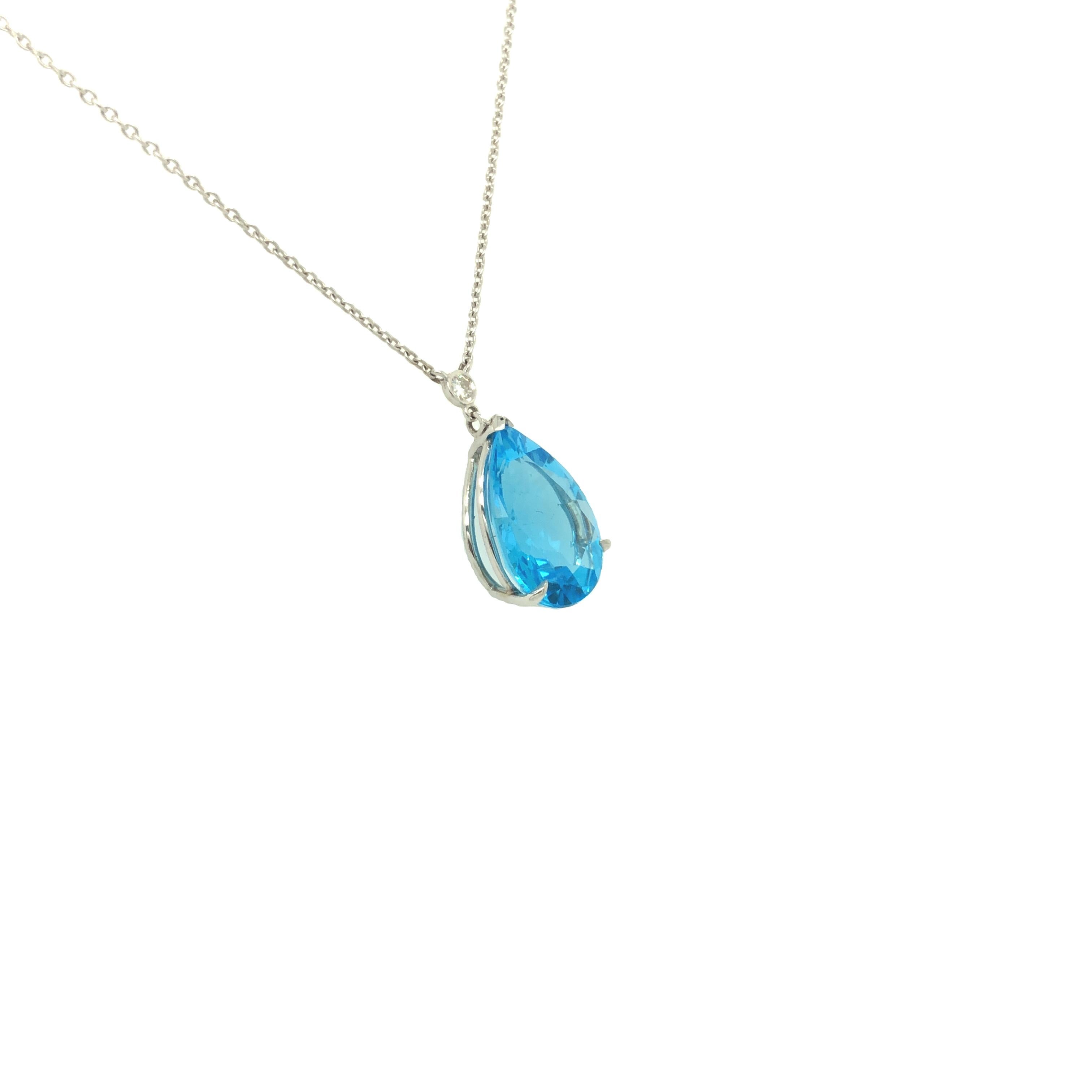 Gorgeous tear drop blue topaz set in fine claw prongs with diamond accent just above. The pendant is crafted in 14K white gold and is suspending on 16 inch long cable chain. The blue topaz weighs 8.87 carats and measures 5/8 inch long. The accent