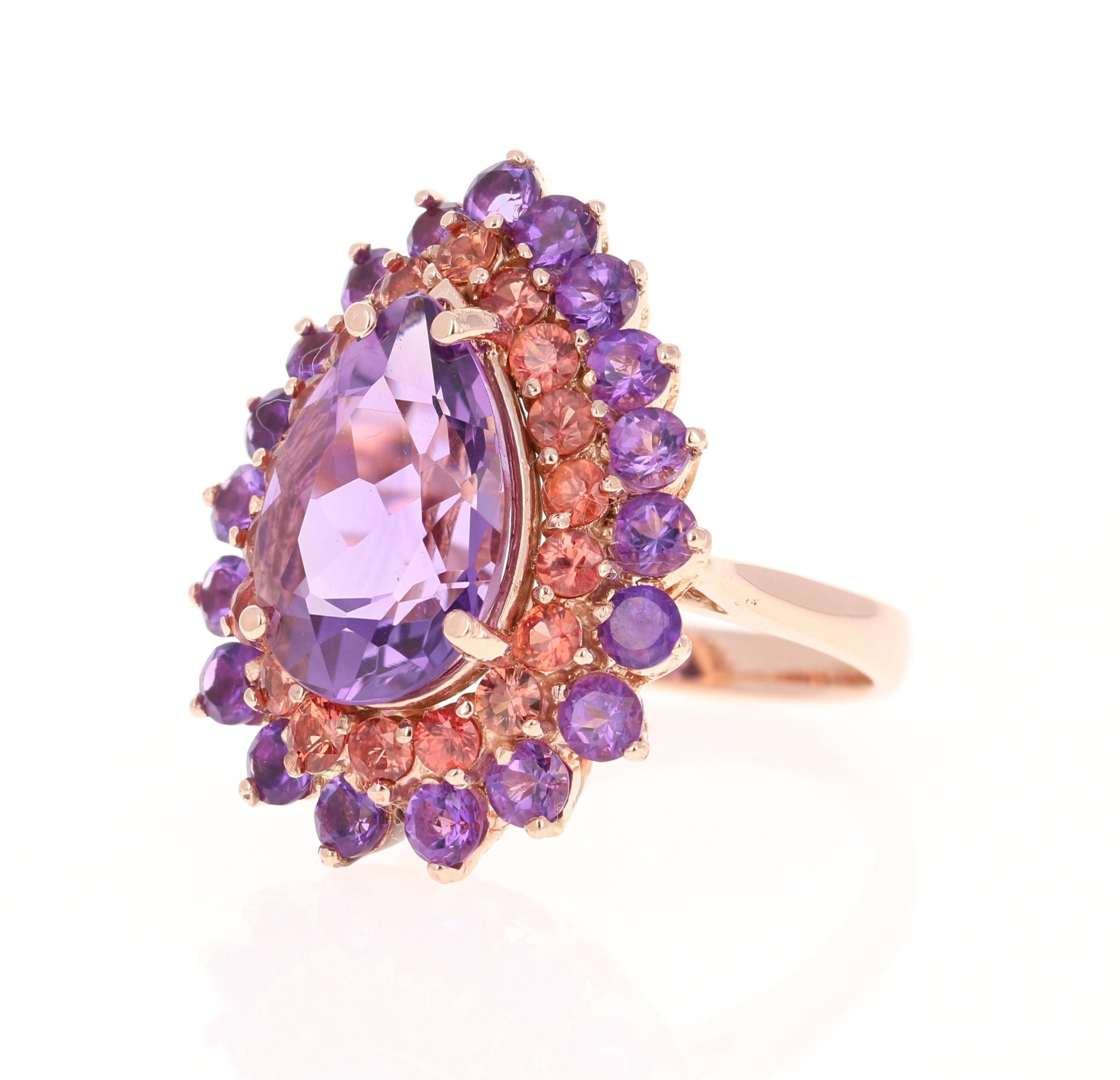 8.90 Carat Pear Cut Amethyst Sapphire 14 Karat Rose Gold Cocktail Ring!
This beautiful ring has a 5.61 Carat Pear Cut Amethyst and is surrounded by a row of sparkling Red Sapphires that weigh 1.44 Carats and a row of Amethysts that weigh 1.85
