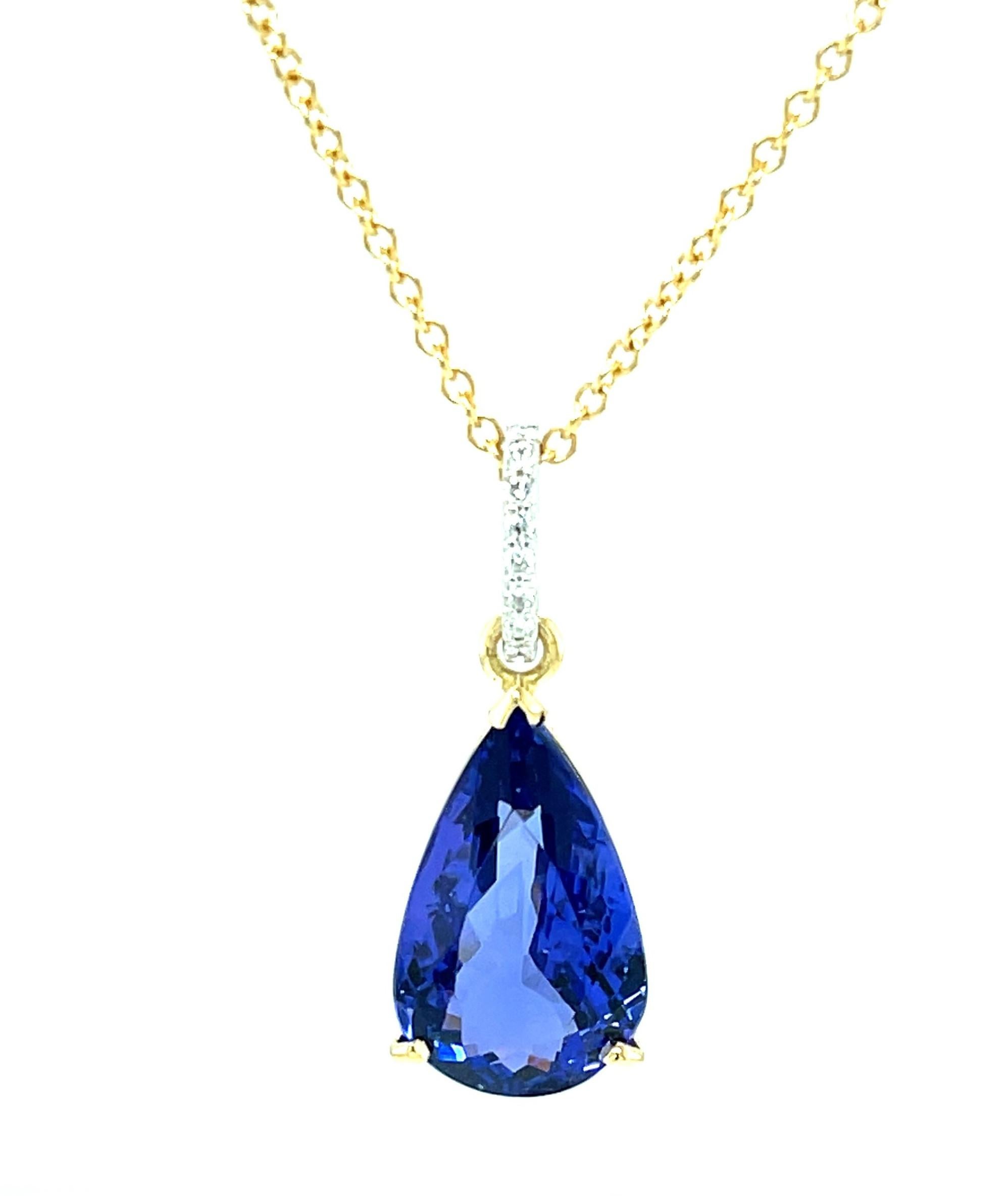 This gorgeous necklace features a fine, 8.90 carat tanzanite with perfect bluish purple color! The pear-shaped tanzanite is set in an 18k yellow gold basket that was custom-made especially for this gem. Brilliant white diamonds have been set in the