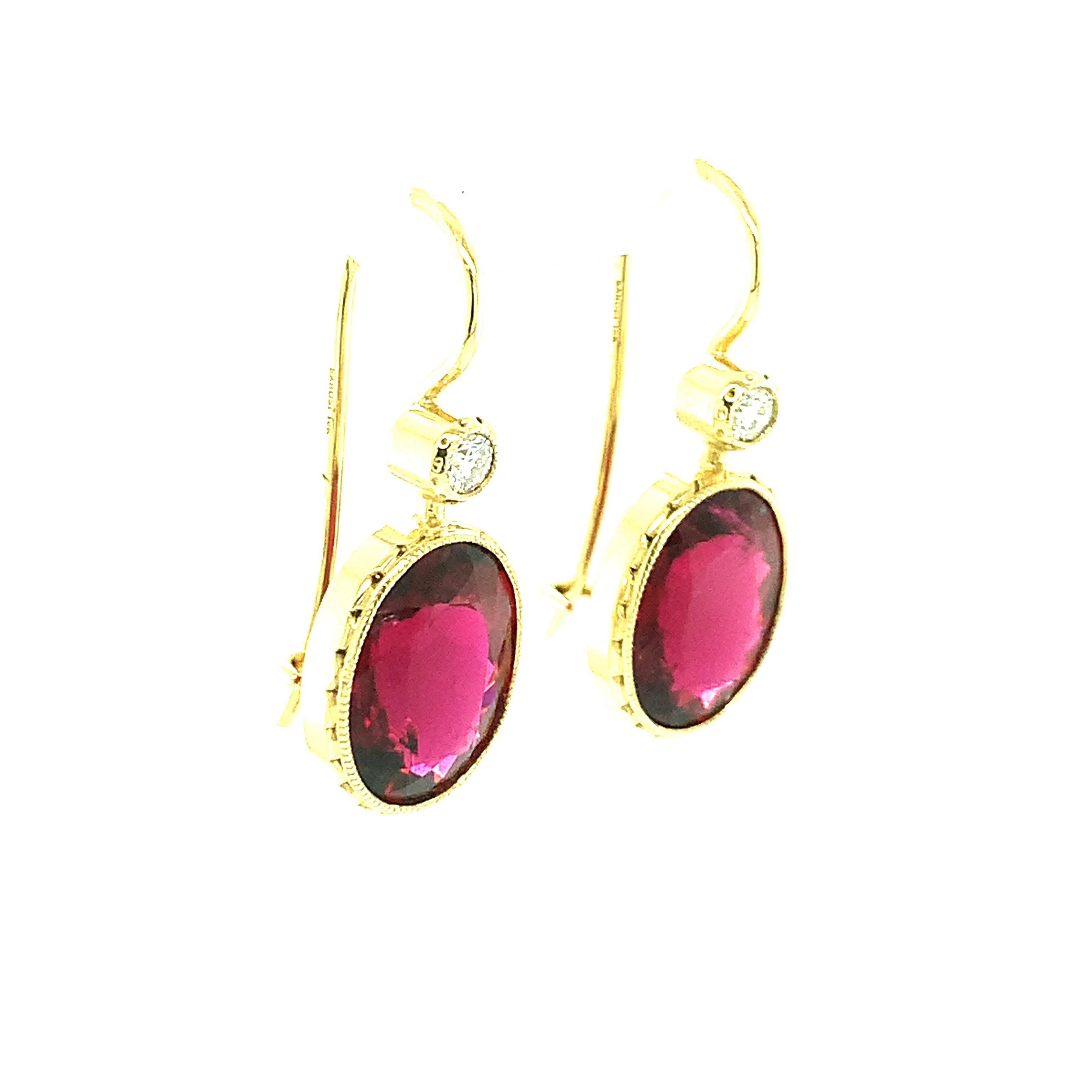 These beautiful rubellite tourmaline and diamond drop earrings will elevate any outfit with their eye-catching burst of color! Reddish-pink tourmaline as richly colored and vibrant as these are very rare, and especially hard to find in large matched