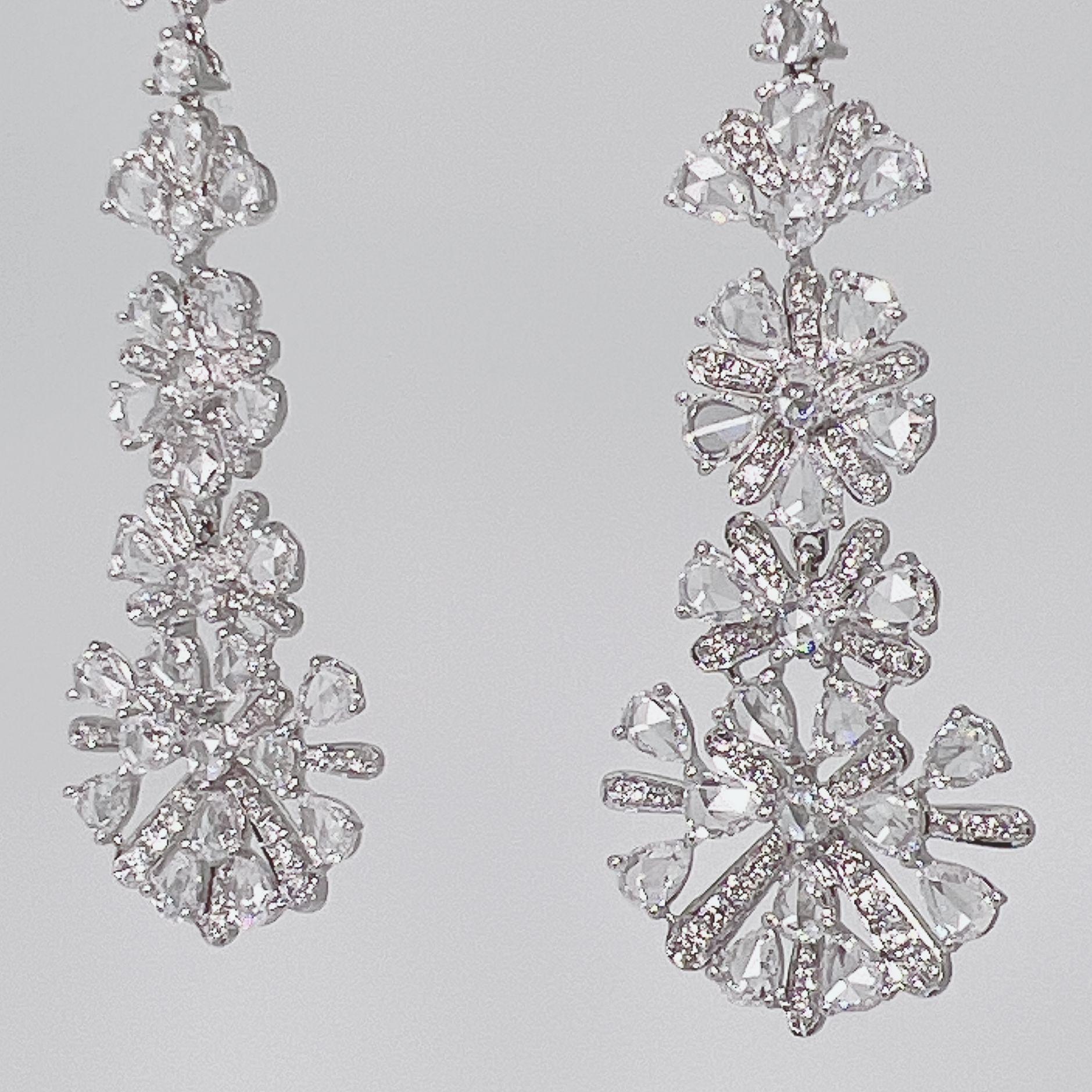 A stunning pair of dangling Snowflakes earrings featuring 202 pieces of Rose cut and Round Brilliant cut Diamonds weighing 8.95 carats.  Earrings are set on 18 Karat White Gold and is crafted with top craftmanship.  This stylish and unique piece