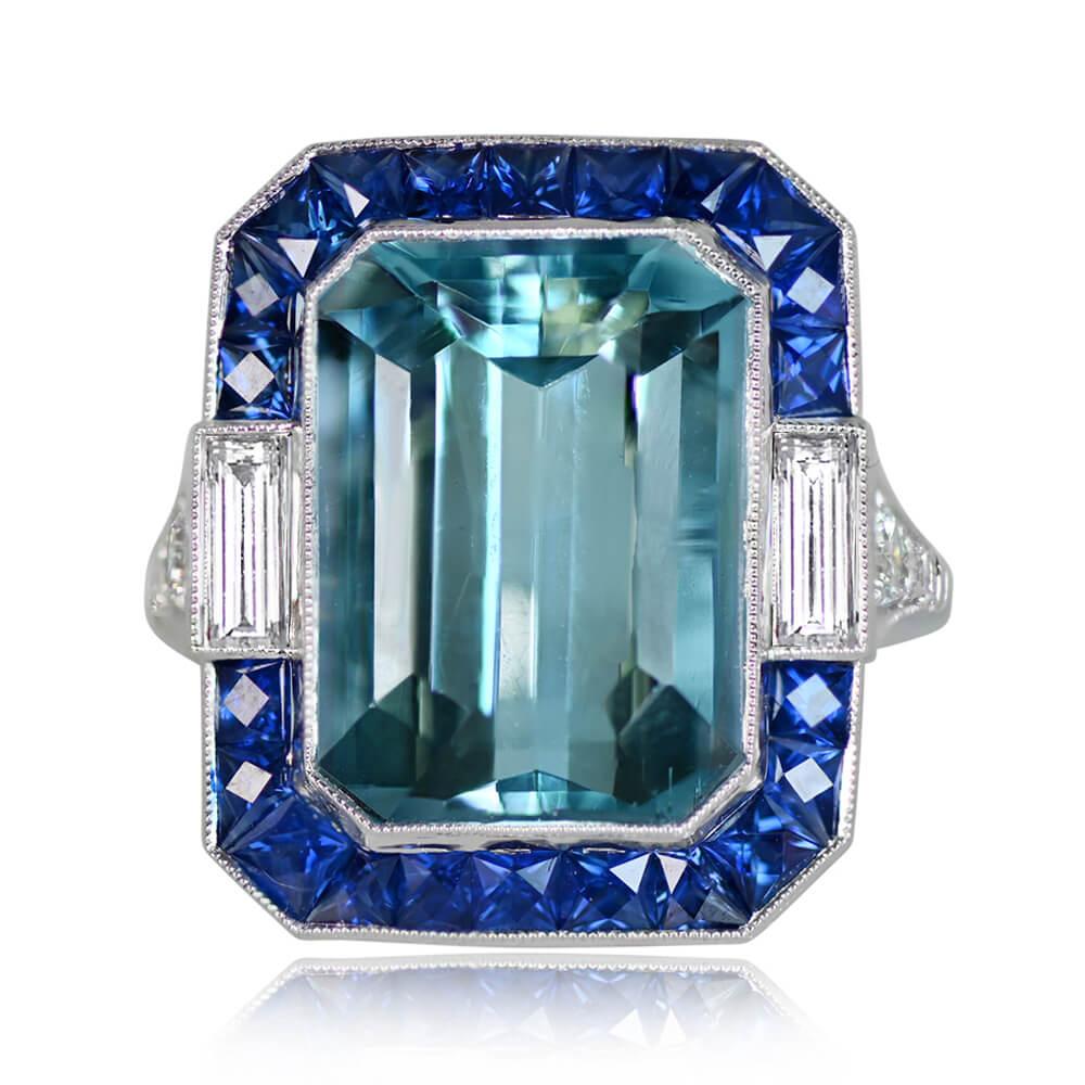 This ring features a stunning 8.95-carat emerald-cut aquamarine, complemented by diamonds and sapphires. Baguette-cut diamonds and French-cut sapphires create a captivating halo around the aquamarine, while round brilliant-cut diamonds adorn the