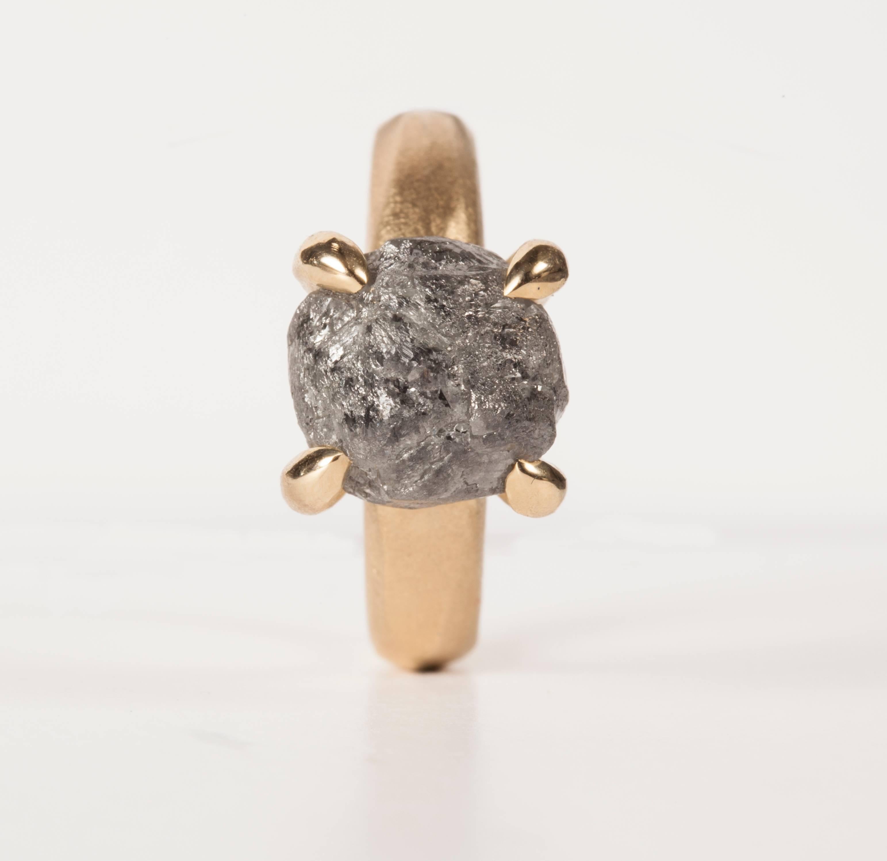 8.96 ct. Natural Black-Greyish Rough diamond in 14K handcrafted gold ring.

Every rough diamond from Roughdiamonds dk has been personally handpicked by Maya Bjørnsten. The diamonds we reject are sent back to be cut into regular diamonds. All the