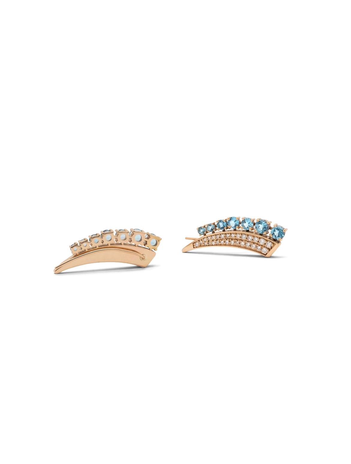 Climb right on up! Elevate your earring game with these stunning ear climbers. Adorned with diamonds and blue topaz, they are sure to make you the centre of attention. The special shape allows for the crawler to follow the curved contour of the ear