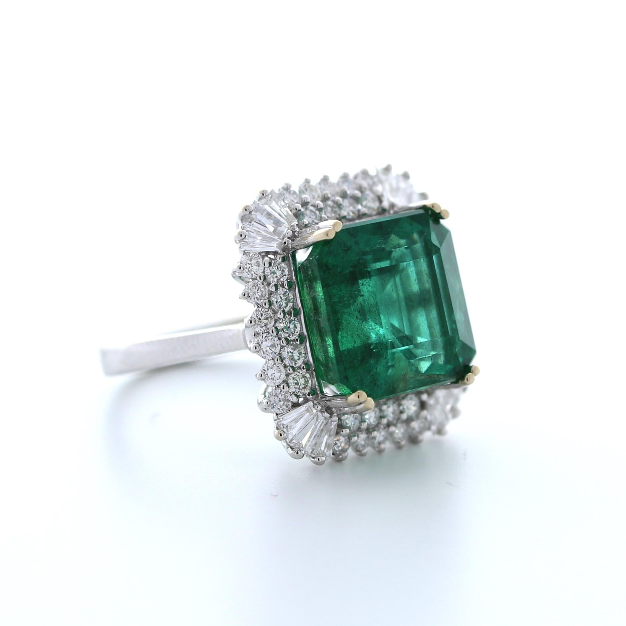 This striking 8.97 carat weight green emerald fashion ring is a true work of art. The emerald is a stunning shade of green and boasts exceptional clarity and brilliance, weighing in at an impressive 8.97 carats. It is set in luxurious 18K white gold