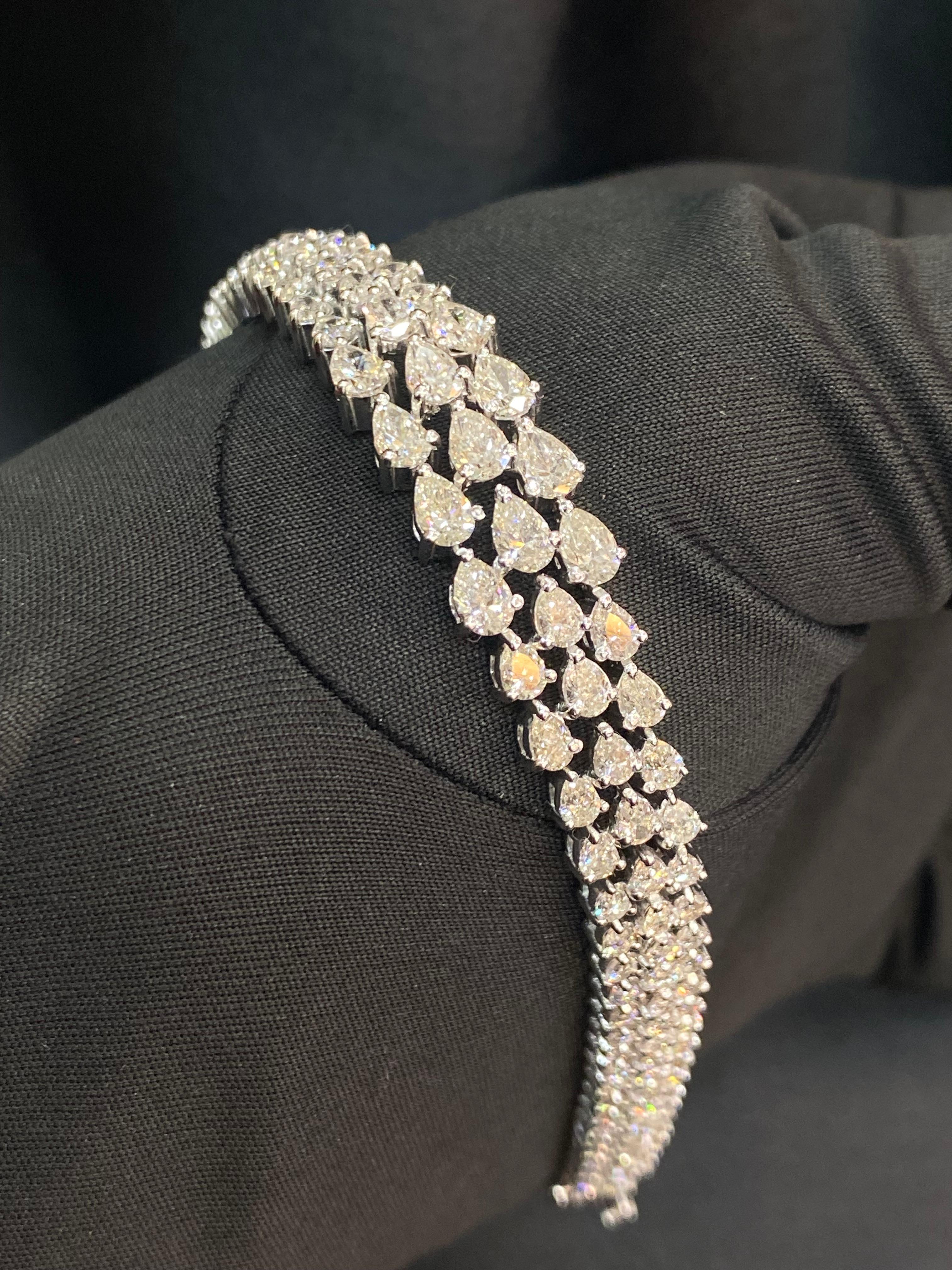 A bracelet holds a special charm, capable of igniting a million-dollar smile. Embrace the enchantment with our captivating 8.97 carat pear-shaped diamond tennis bracelet. Let this exquisite beauty bestow upon you a regal aura, making you feel truly