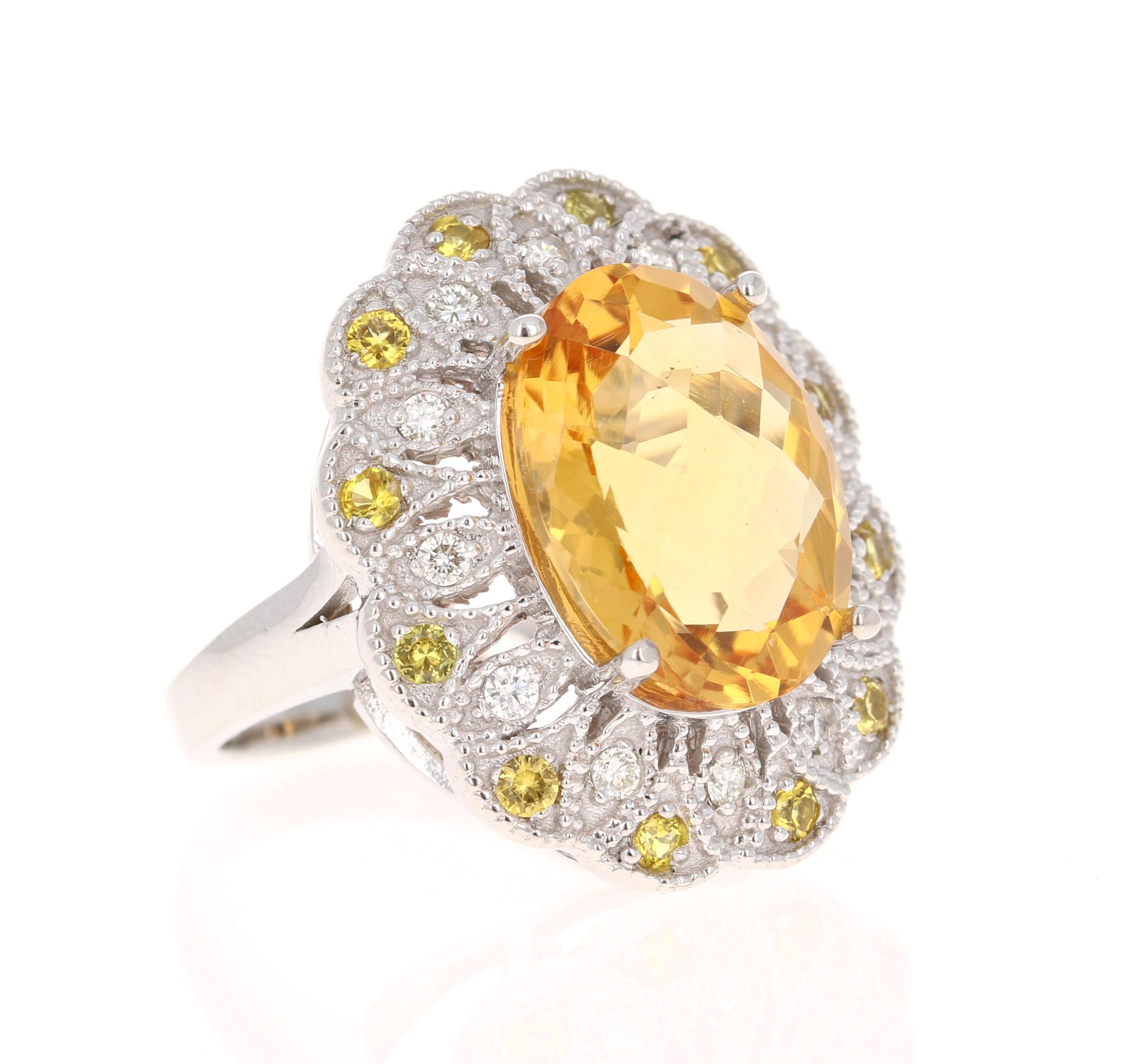This beautiful ring has a Oval Cut Citrine that weighs 8.15 Carats. It is surrounded by 12 Yellow Sapphires that are round cut and weigh 0.53 carats (Clarity: VS, Color: H). There are also 12 Round Cut Diamonds that weigh 0.30 carats. The total