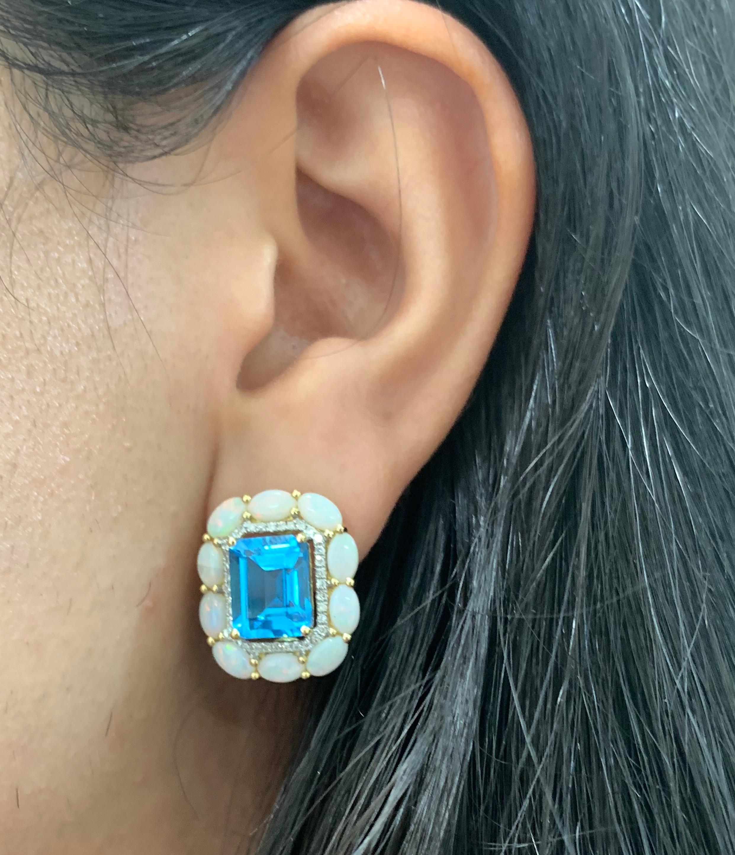 Material: 18K Yellow Gold 
Stone Details: 2 Emerald Cut Blue Topaz at 8.99 Carats Total
Surrounding Stone Details: 20 Oval Opals at 2.87 Carats
Diamond Details: 72 Brilliant Round White Diamonds at 0.28 Carats - Clarity: SI / Color

Fine