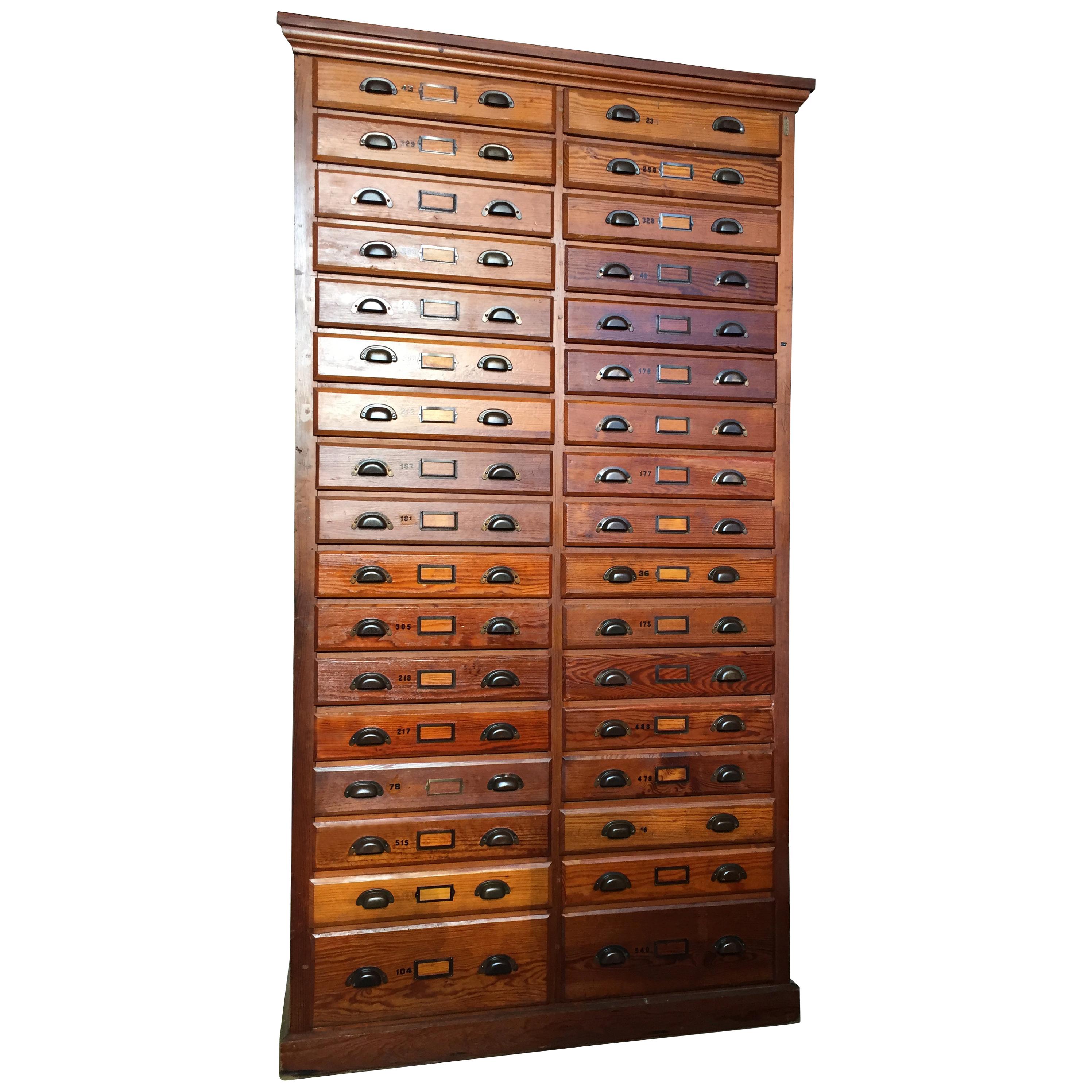 8FT antique printer's flat file cabinet 

Striking 1930s-1940s industrial cabinet featuring 34 drawers. 

Rich warm wood with shell metal pulls.

Would be ideal for an artist or retail space.

Measures: 92.5