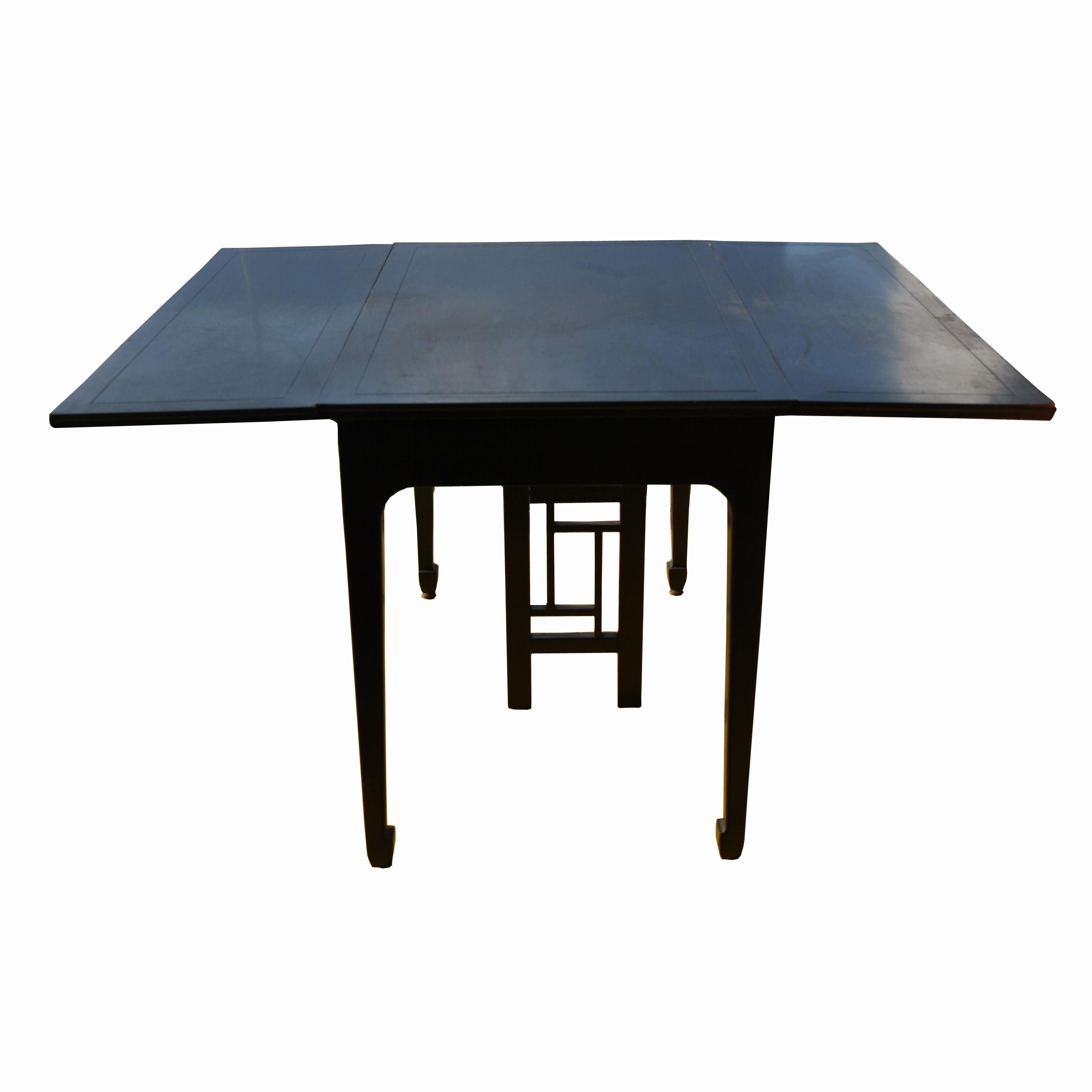 Far East collection 
 
1960s.
A dining table designed by Michael Taylor and made by Baker showing an Asian influence. Solid construction in an ebonized walnut finish.
Incised apron and tapered Ming style legs.
4 leaves 
Table extends to 8 ft.