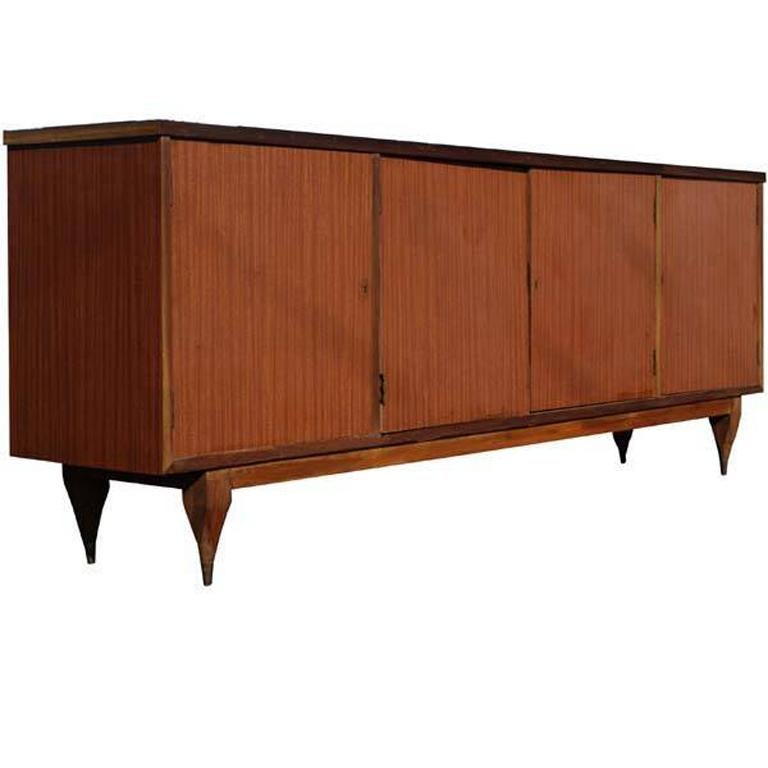 8ft vintage Italian credenza breakfront sideboard
 
Features:
(2) Middle opposing cabinets doors with interior shelf
(2) Side cabinet doors with interior shelves in each side
Wood construction
Laminate top with wood finish
Tapered legs with