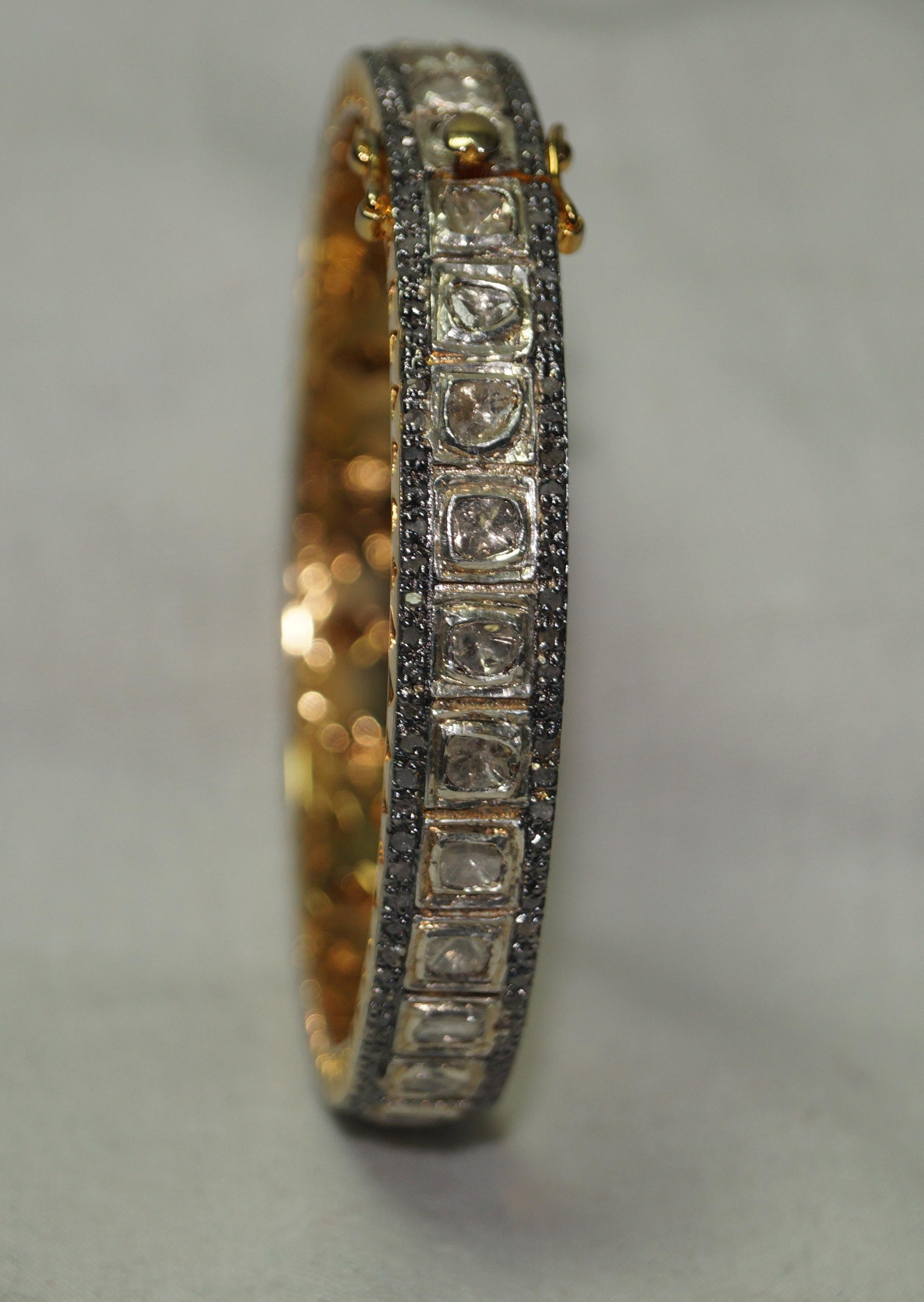 This stunning bangle bracelet is one of its kind.
It consists of:
Diamond- Natural diamonds
Diamond color- Tinted yellow
Metal- 18k gold and sterling Silver
Metal purity- 925 silver or sterling silver
Size- 8