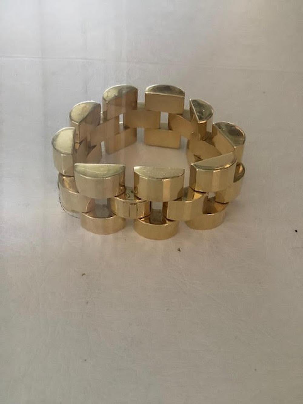 This stunning vintage 1980's 18K gold Italian link cuff bracelet is fabulous on the wrist. It is in the style of art deco influences and made in the 1980's or even before. It has staggered links of 18K gold as the design to form a cuff and is