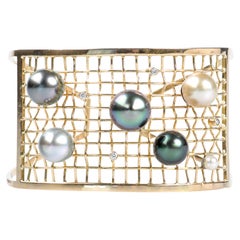 8K yellow gold cuff bracelet with 6 pearls and 4 diamonds.
