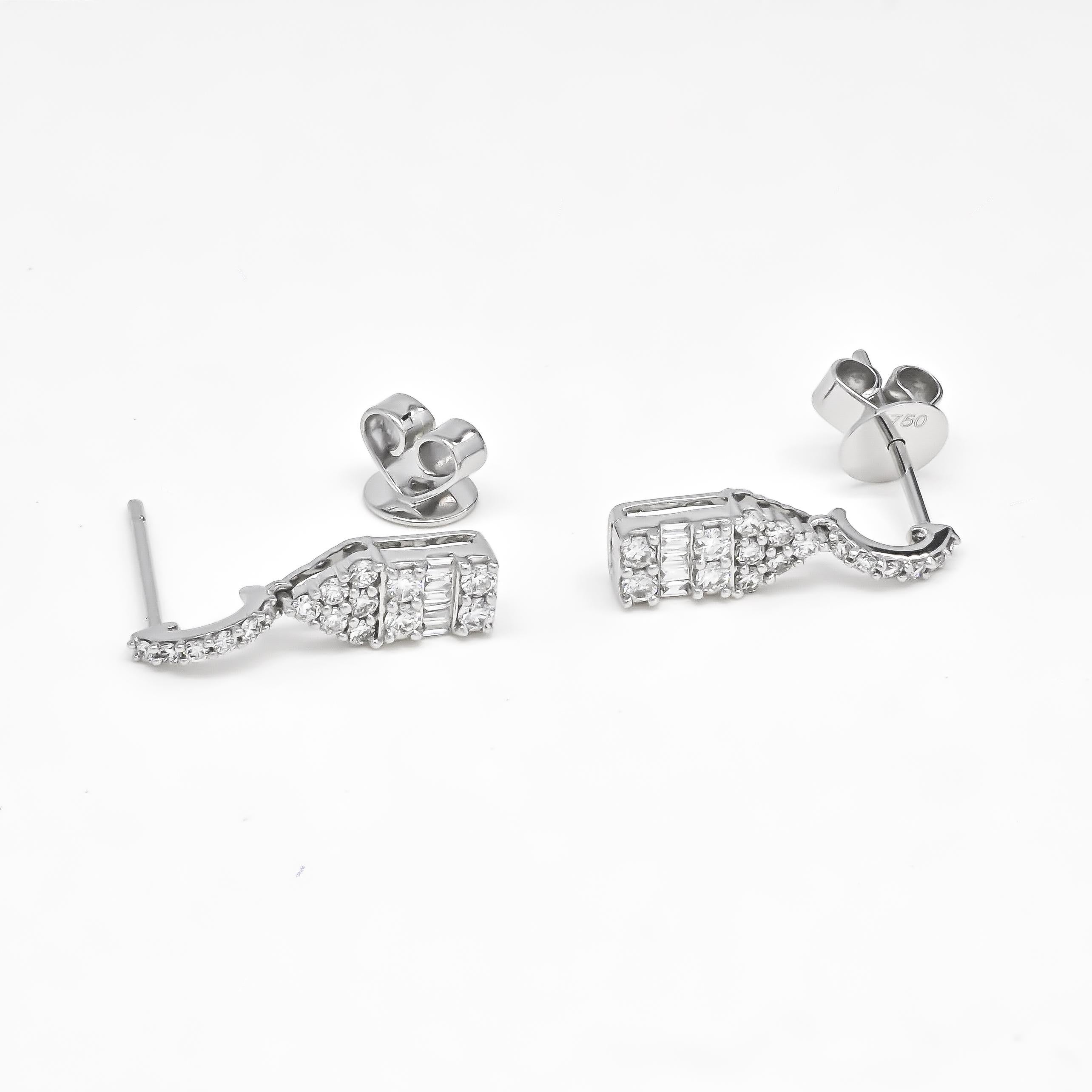 Minimalistic diamond 18KT white gold drop danglers earrings are the perfect accessory for young women who want to make a statement at a party. These earrings feature a simple yet elegant design that complements any outfit and adds a touch of