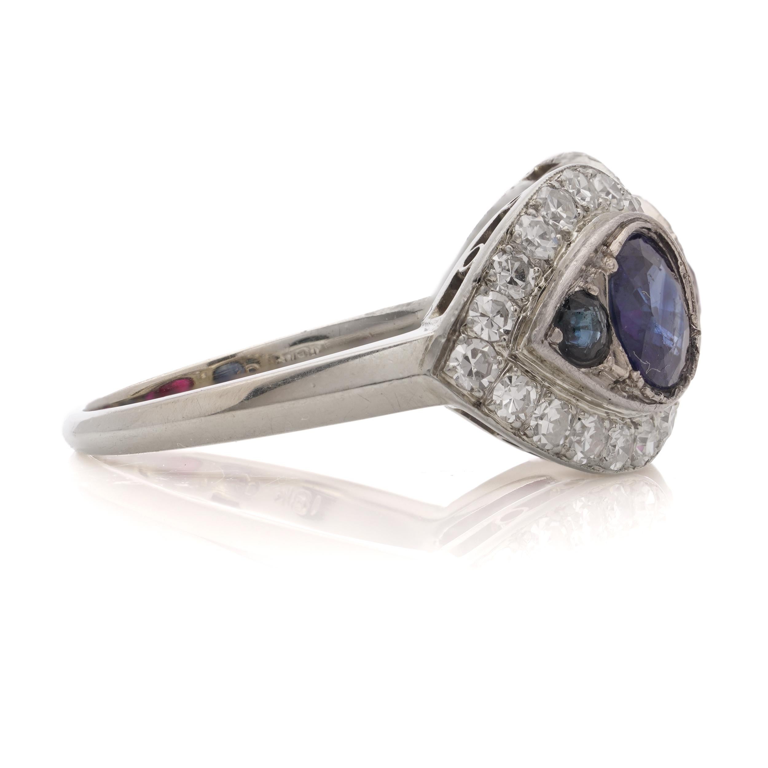 18kt. white gold ruby and sapphire ring, surrounded by round brilliant diamonds For Sale 1