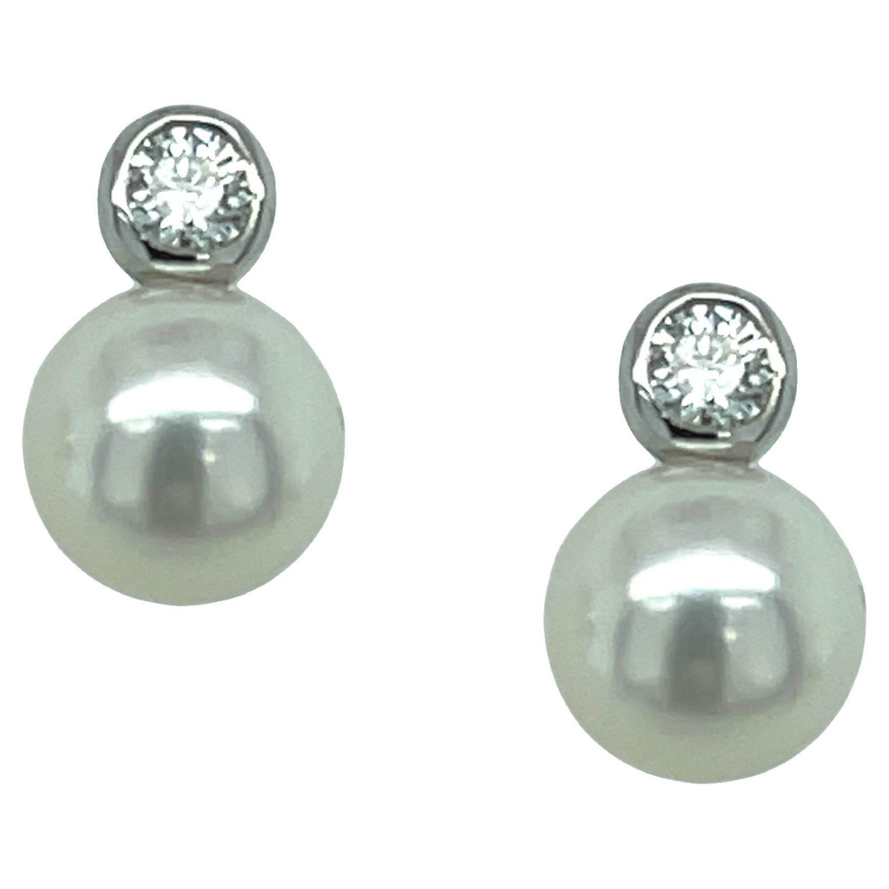 These gorgeous pearl and diamond stud earrings feature a beautifully matched pair of 8.00 mm Akoya saltwater pearls set in 14k white gold. A single 3.30 mm round brilliant cut diamond has been bezel set above each pearl for a more contemporary look