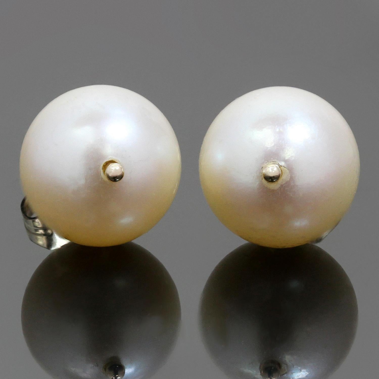 These elegant classic stud earrings are crafted in 14k yellow gold and set with 8.5mm pink cultured pearls. Made in United States circa 2010s. Measurements: 0.31