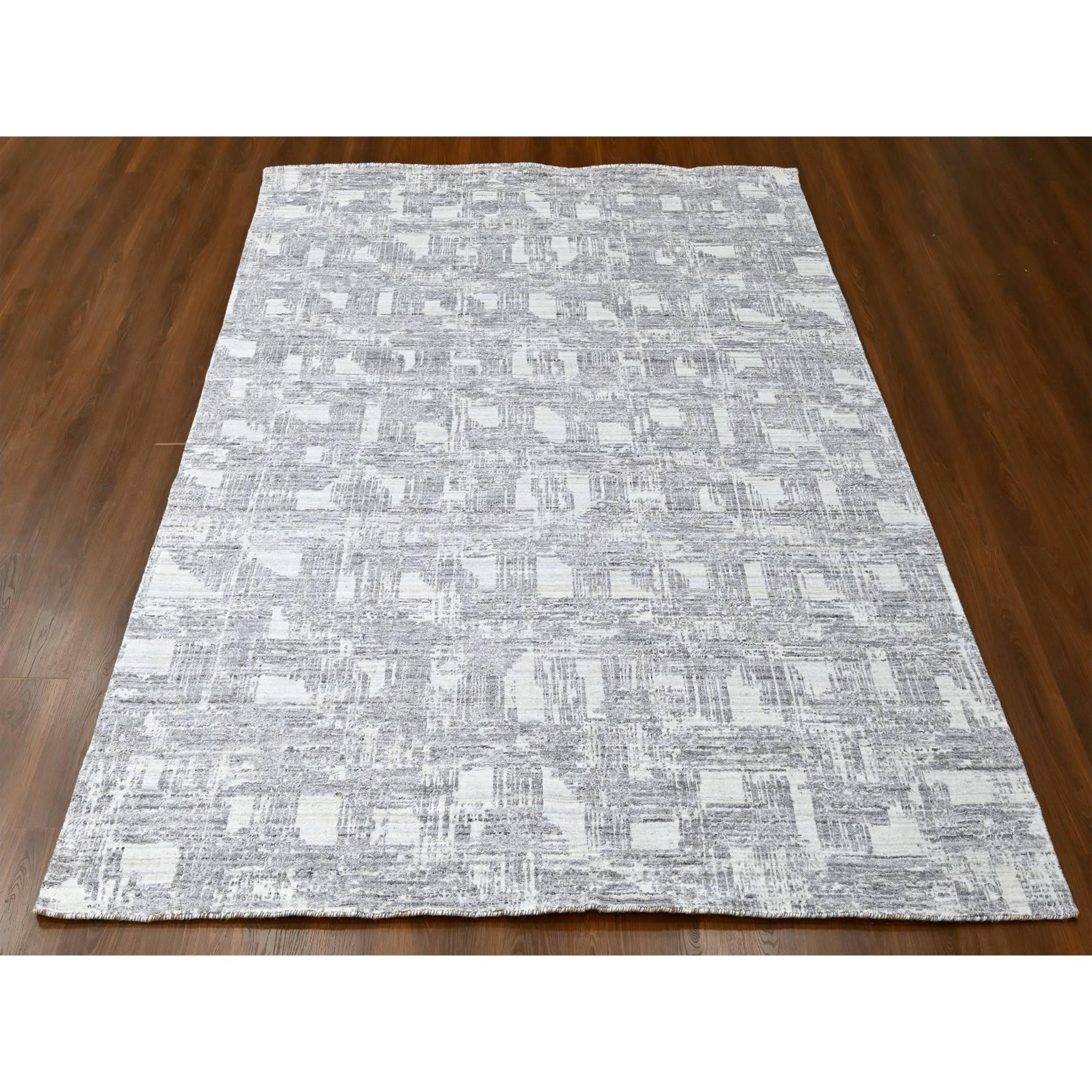 Chiffon White, Hand Loomed, Wool and Plant Based Silk, Textured Pile, Modern Grid Like Design, Oriental Rug
Primary materials: Wool & Silk
Latex: No Pile 
height: 0.25 Inches
Style: Contemporary
Primary color: Ivory
Secondary colors: Black,