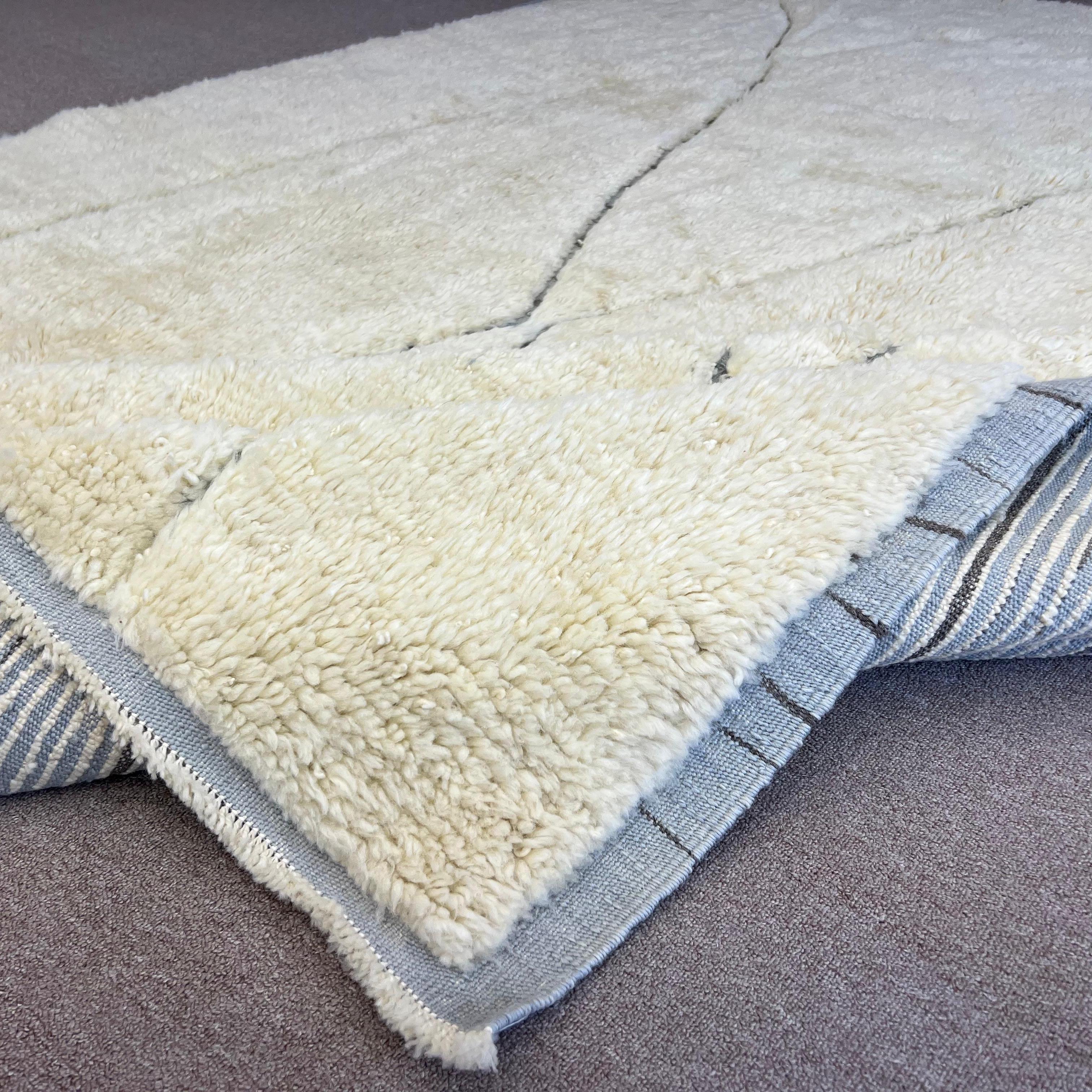 Elevate your living space with the exquisite charm of this new modern hand-knotted Moroccan berber beni ourain rug, crafted with precision and care from 100% wool. Combining the allure of Moroccan design with contemporary sensibilities, this rug is