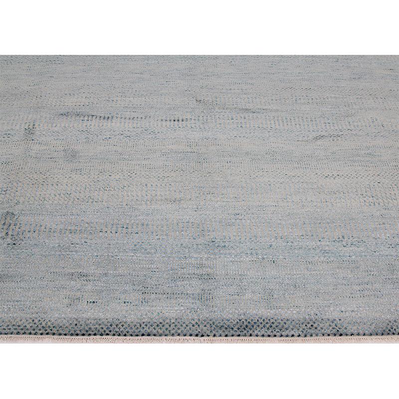 Handwoven Transitional Indo Rug from RenCollection rugs — handwoven transitional Indo rug featuring a simply elegant all-over design in a turquoise color accented with ivory. Created with 100% wool and silk by the artisans of India.

 

Care