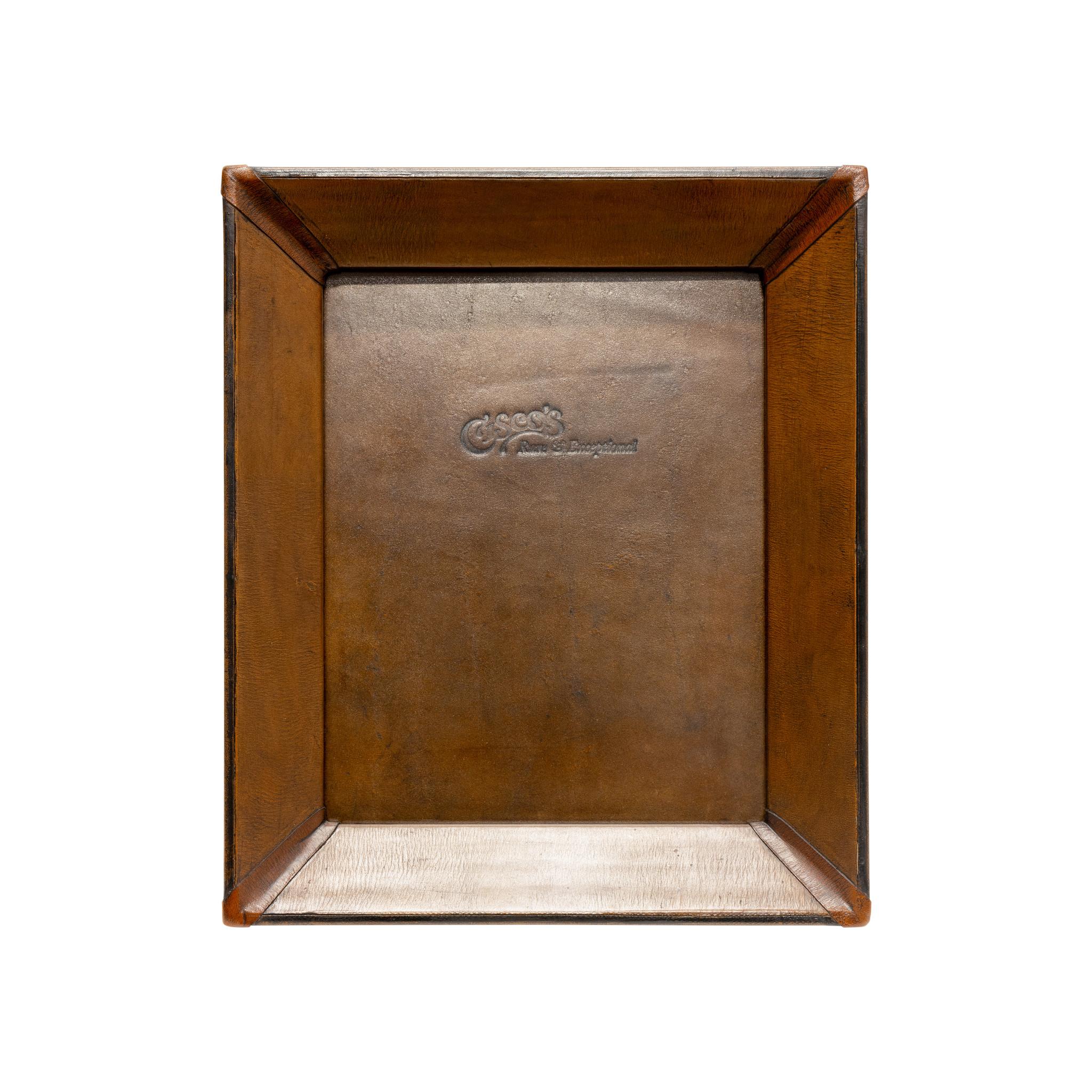 8x10 medium brown & black leather tabletop picture frame. Premium leather picture frames add the perfect accent to any home or office. Each frame is skillfully crafted by artisan saddle makers using genuine cowhide. Color: Medium brown with