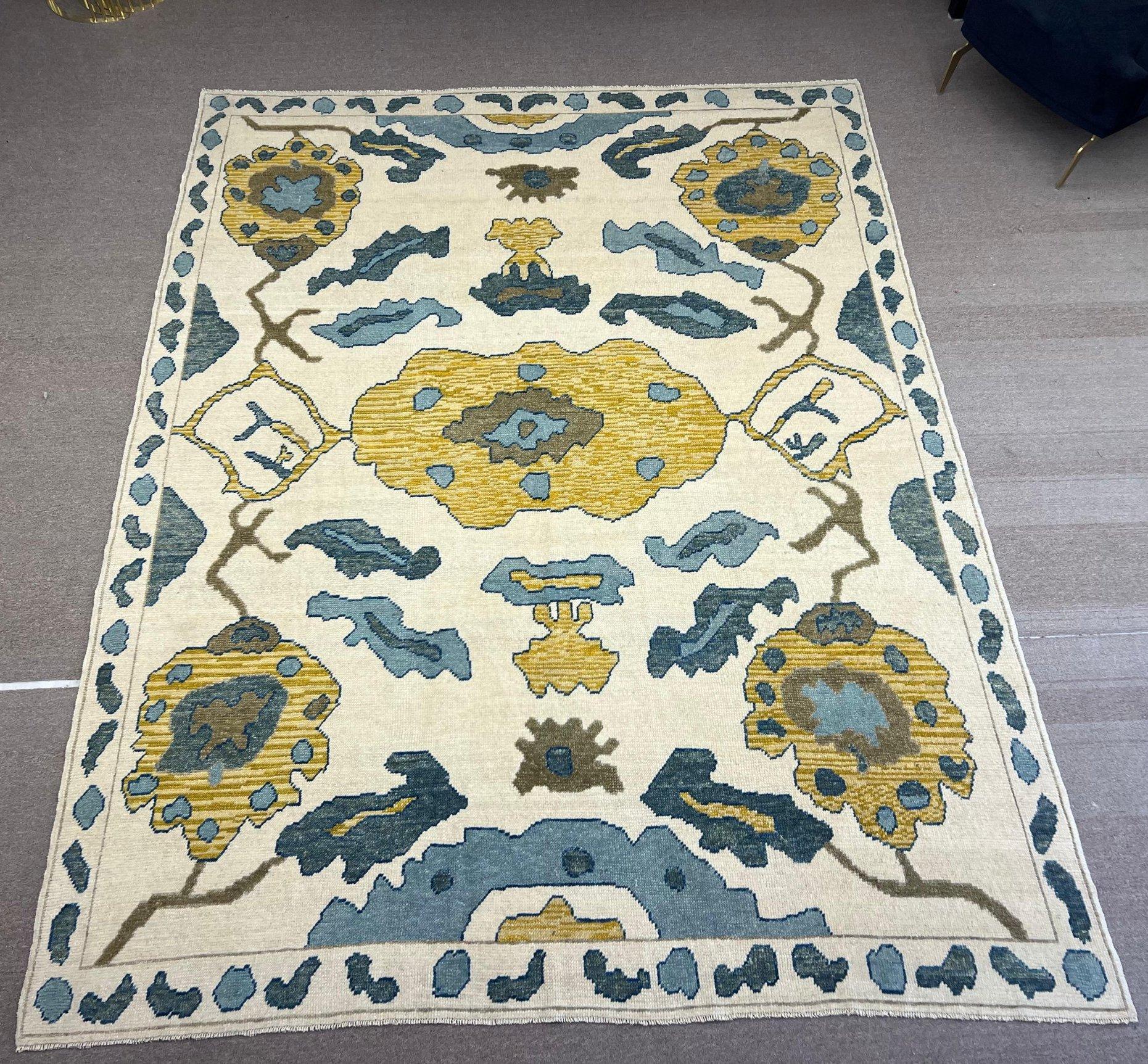 Elevate your home with the timeless beauty of this new hand-knotted Turkish Oushak rug, crafted from 100% wool using traditional techniques passed down for generations. Renowned for their soft, luminous wool and elegant floral motifs, Oushak rugs