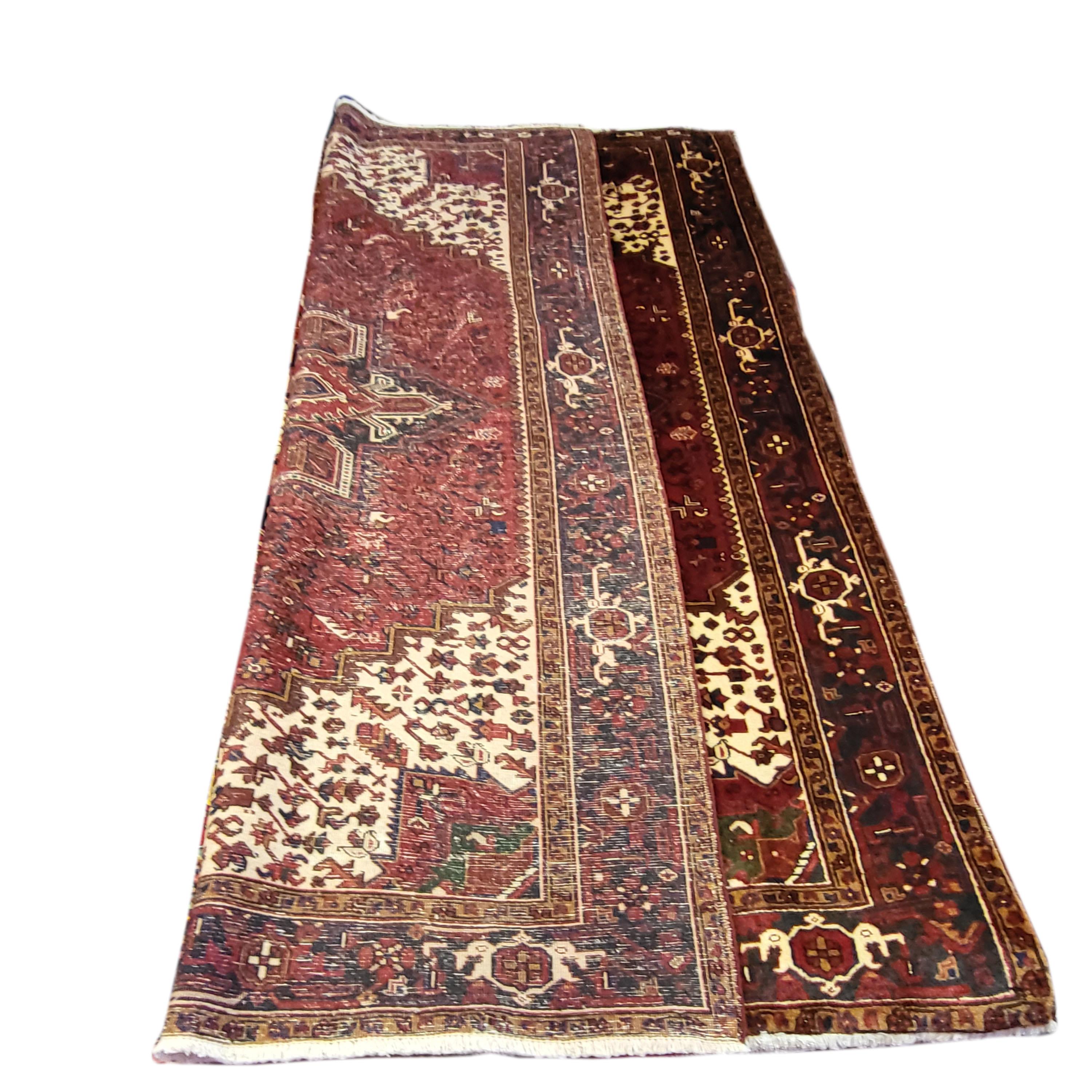 Gorgeous 8' x 11' authentic, vintage Persian Heriz. This is no Indian reproduction, but a fine example of the worlds most popular Persian Rug. Featuring bold tribal inspired design woven with shimmering extra fine wool. The rich cream and maroon are