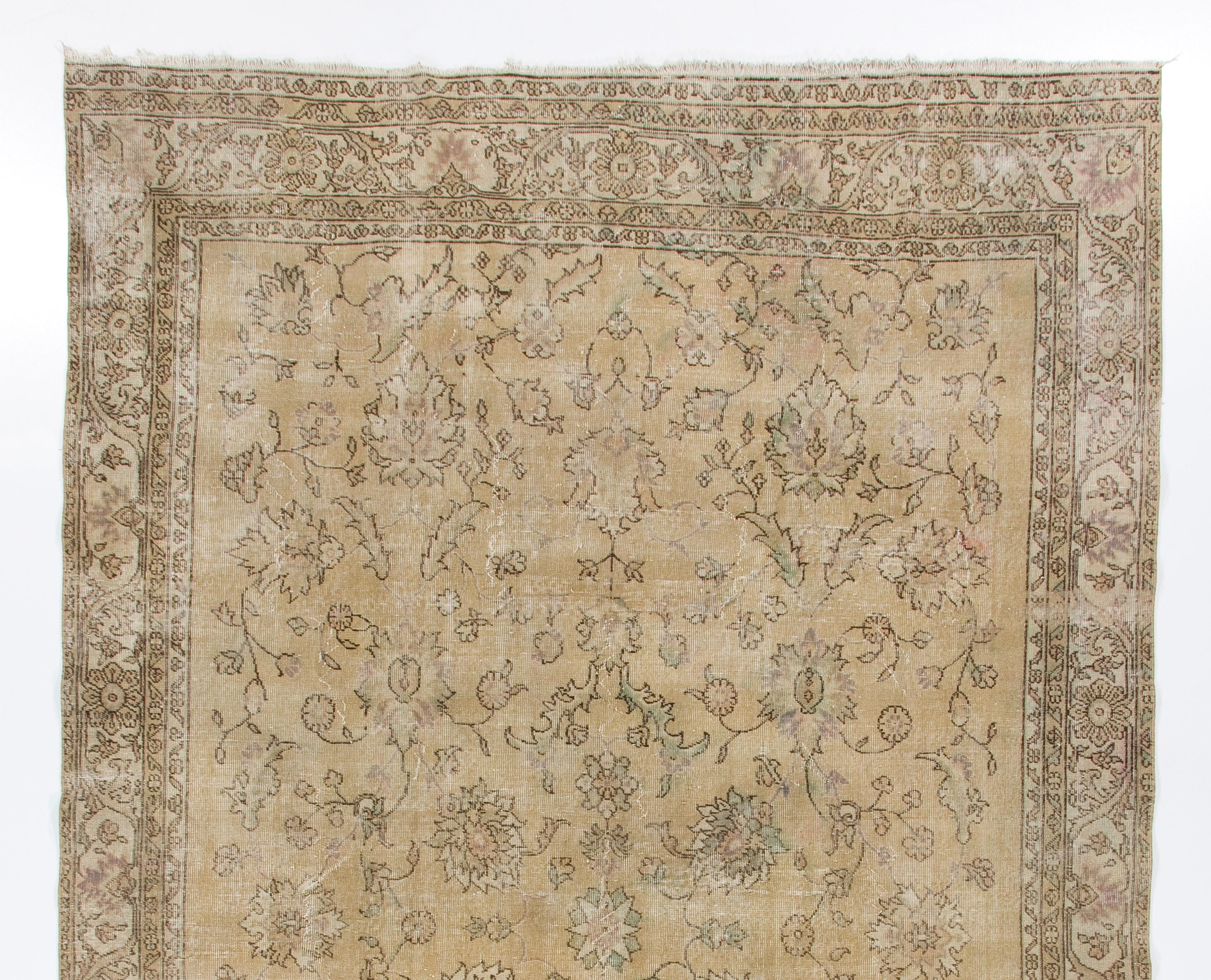 A large, finely hand-knotted vintage Turkish Oushak area rug from the 1950s with a classical design of large rosettes floating in its field and floral and leafy vines depicted in an eternally graceful and circular form of movement filling the rest