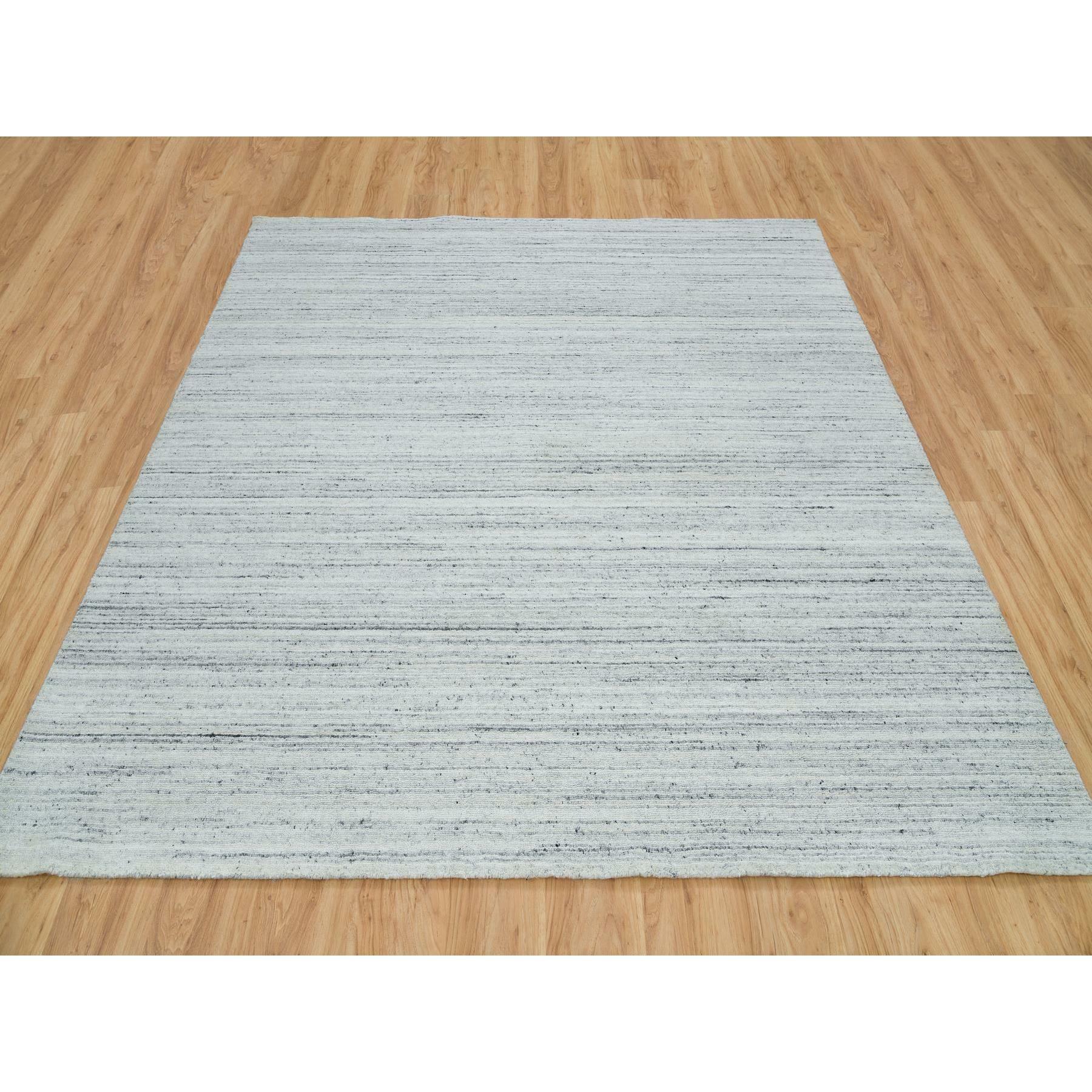 Ash Gray, Modern Striae Design, Tone on tone, Soft Pile, Natural Wool, Hand Loomed, Square Oriental Rug
Primary materials: Wool
Latex: No Pile 
height: 0.25 Inches
Style: Transitional
Primary color: Grey
Secondary colors: Ivory, Gray
Pattern:
