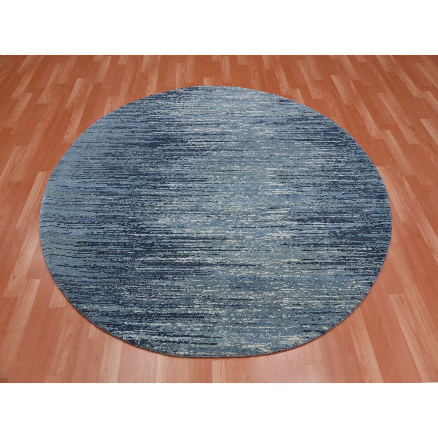 This is a truly genuine one-of-a-kind Blue with Touches of Ivory Hand Knotted Horizontal Ombre Design Pure Wool Round Oriental Rug. It has been Knotted for months and months in the centuries-old Persian weaving craftsmanship techniques by expert