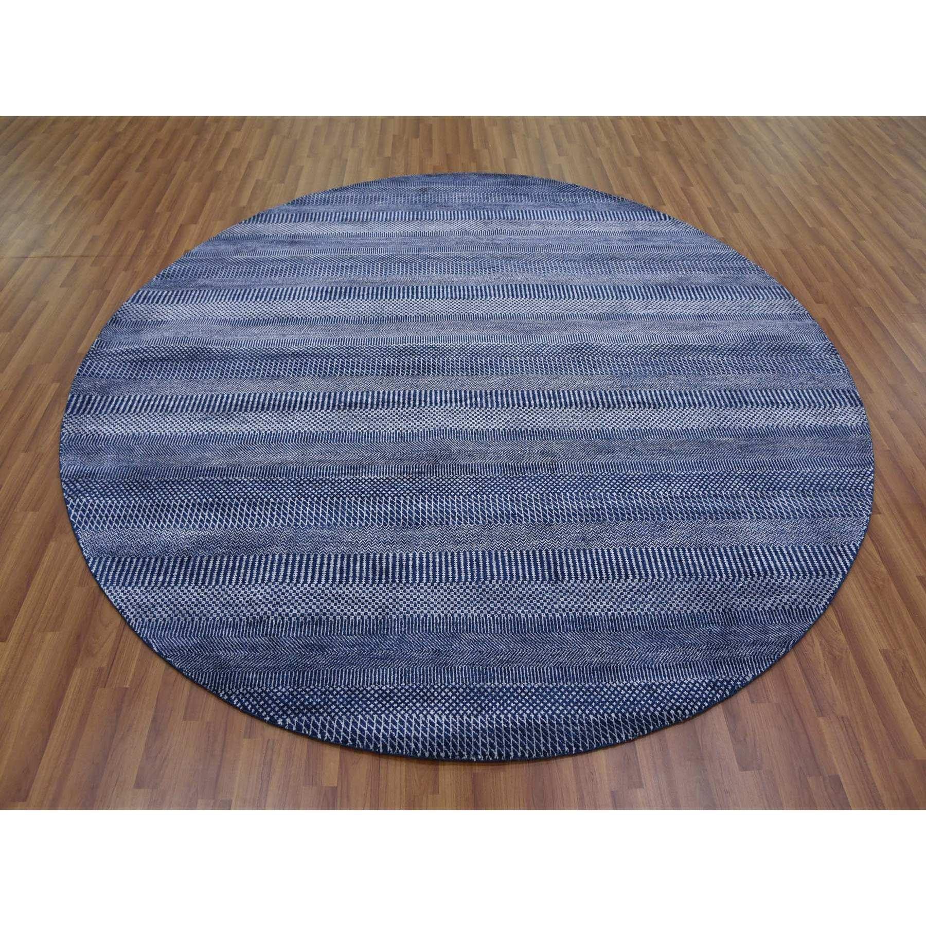 This is a truly genuine one-of-a-kind Navy Blue, Wool and Silk Hand Knotted, Modern Grass Design Gabbeh Densely Woven, Round Oriental Rug. It has been Knotted for months and months in the centuries-old weaving craftsmanship techniques by expert