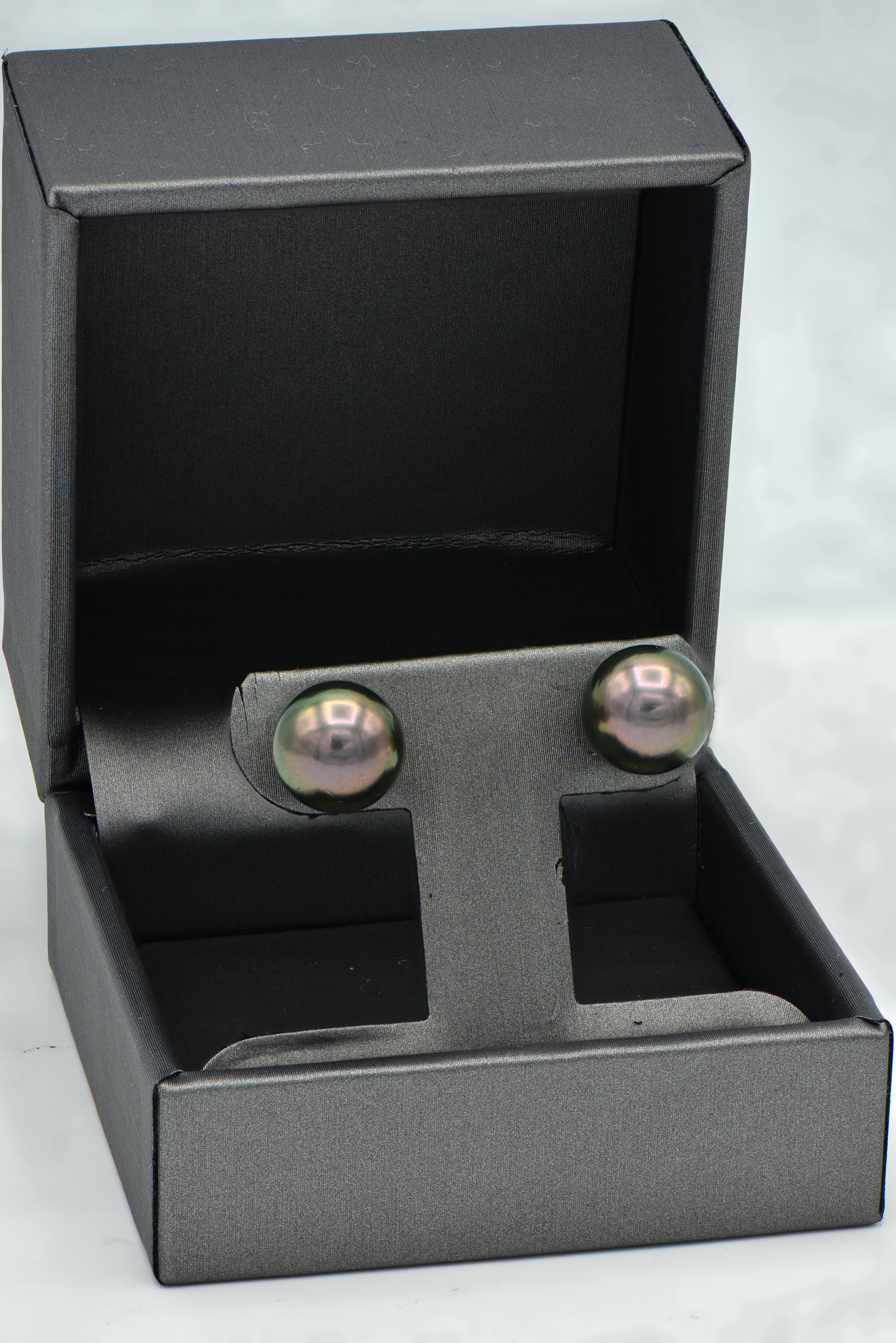Tahitian Pearl Studs give a little twist to the classic white pearl studs. The Tahitian Pearl Studs are expertly matched in color, luster, and size to make a perfect pair. These 9-9.5mm beautiful pearls are set in 14 karat white gold.