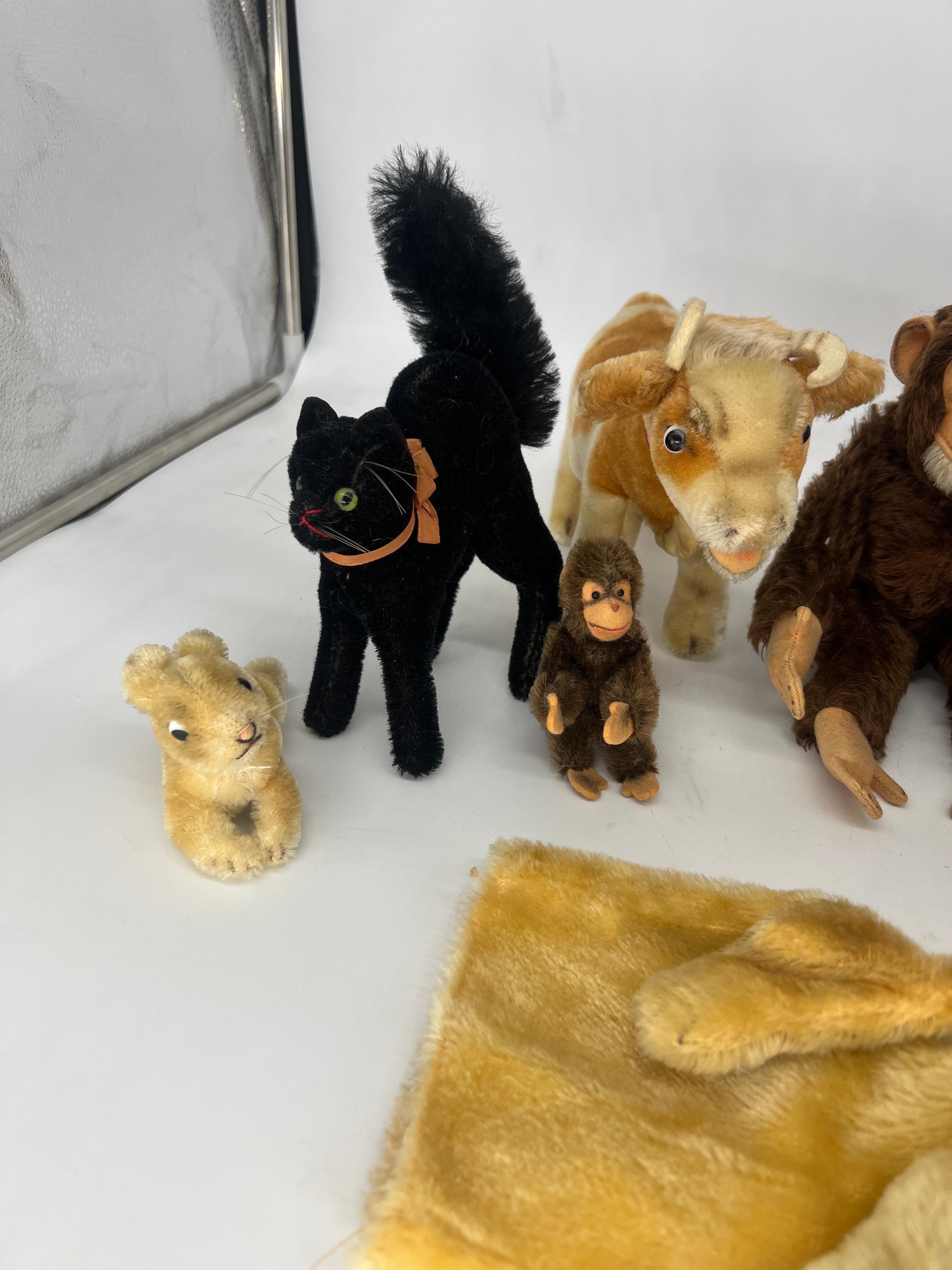 This collection of stuffed animals includes 9 figures:
1) Miniature Steiff Rabbit (No tag, chest weave).
2) RARE Steiff Black Tom Cat (No Tag).
3) Miniature Steiff Monkey (No Tag, chest weave).
4) Steiff Cow 