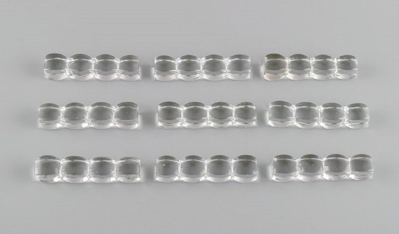 9 Art Deco knife rests in clear art glass. France, 1930s / 40s.
Measures: 8 x 2 cm.
In excellent condition with micro chips.