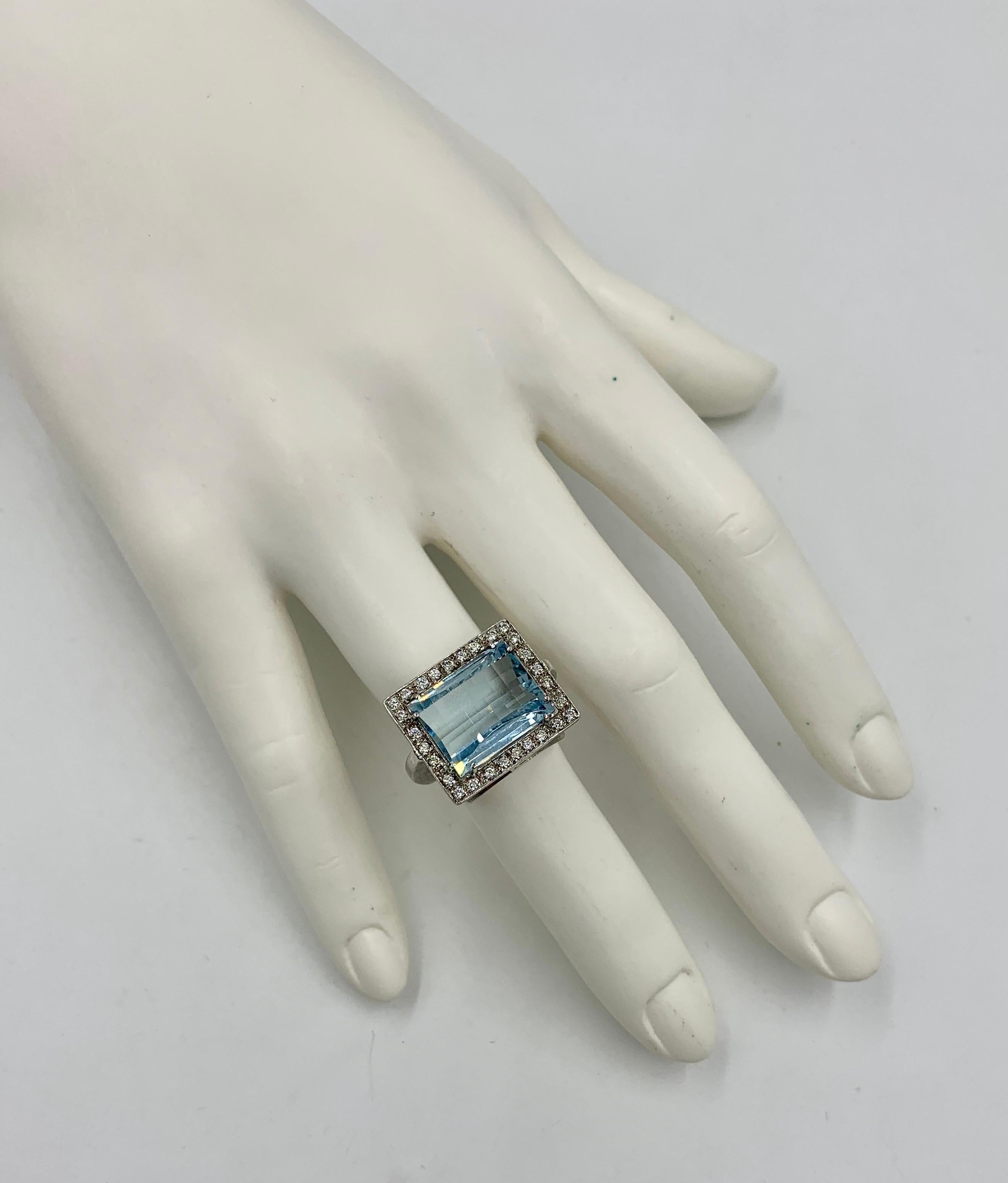 A spectacular Ring with a 9.0 Carat Fancy Beveled Checkerboard Cut Aquamarine surrounded by 30 gorgeous sparkling Diamonds set in 18 Karat White Gold.  The stunning Aquamarine is a light sky blue with a checkerboard curved top.  The Aquamarine is