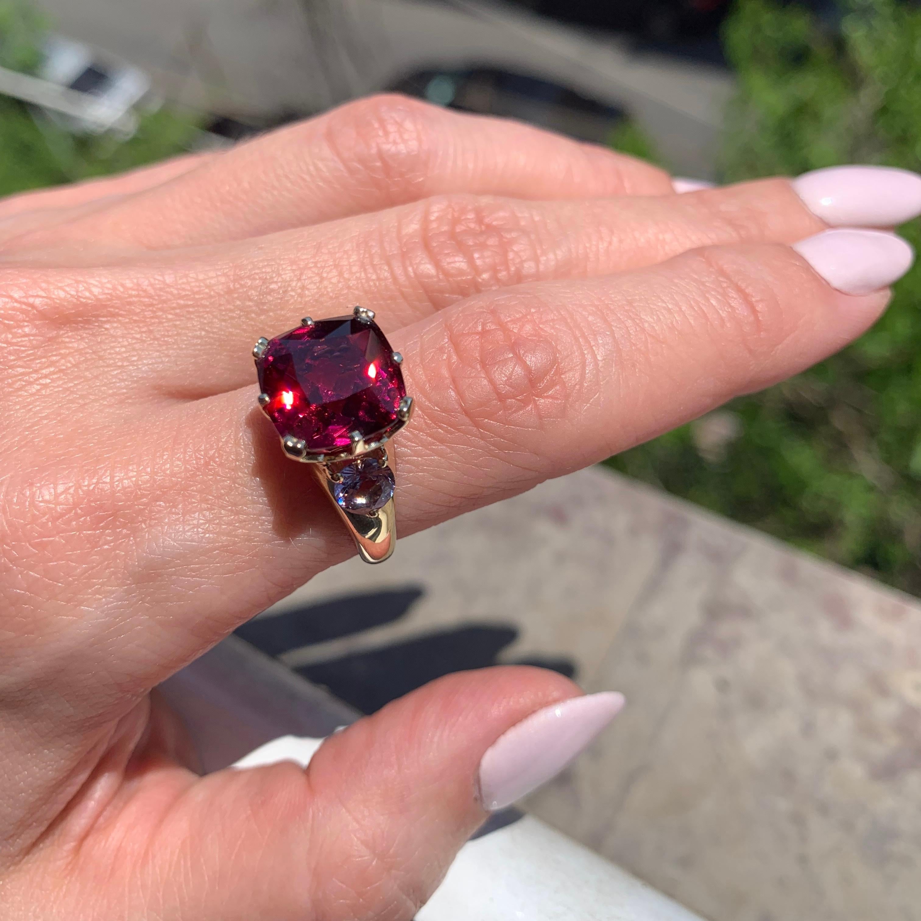 In this ring you can see the ideal combination of gemstones, and it immediately attracks the attention: amazing natural burgundy red rhodolite garnet in quite big size - 9 carat and delicate purple eye clean spinel that increase the shine and color