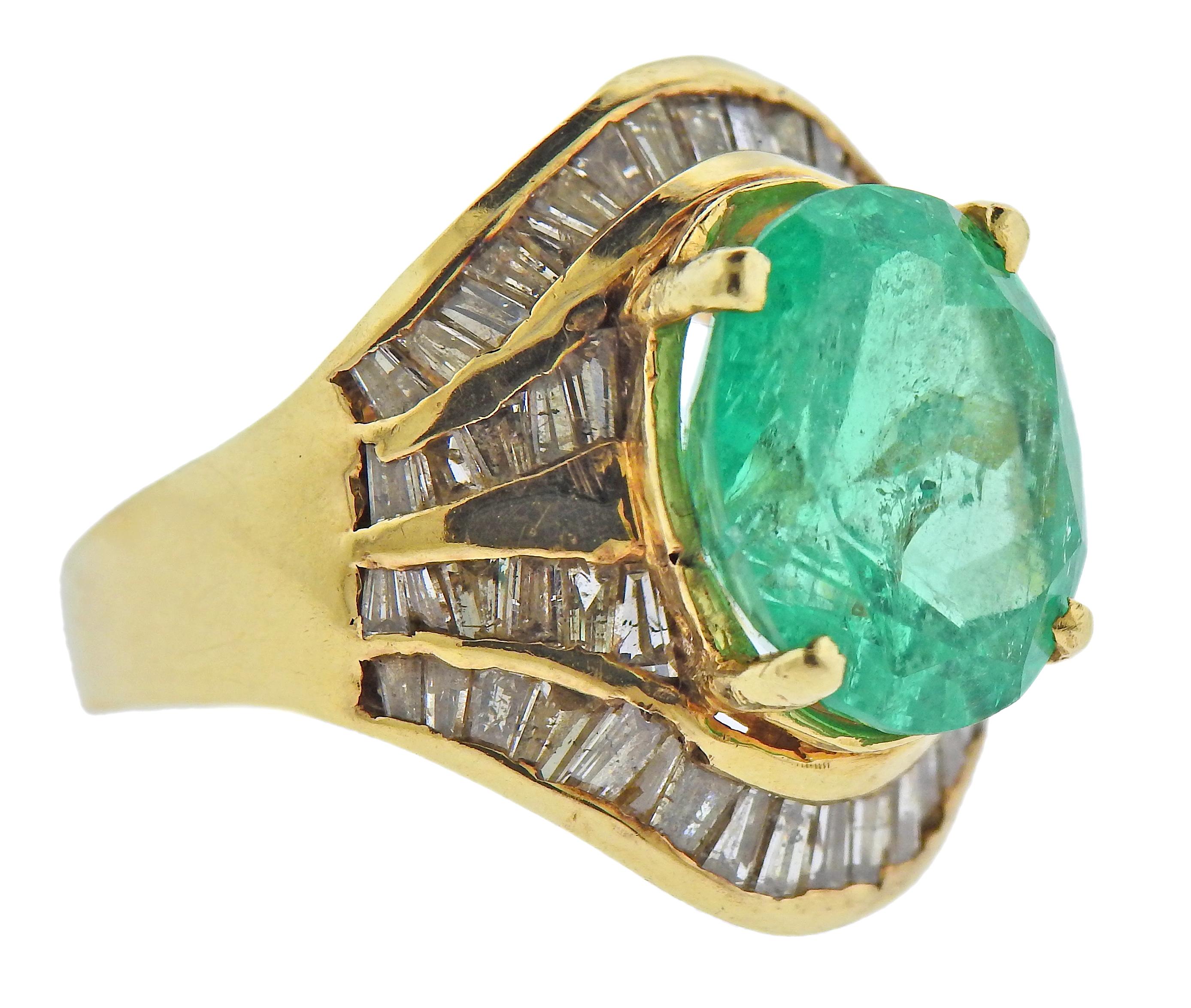 14k gold cocktail ring, set with oval approx. 9 carat emerald (measuring 14.1 x 12.35 x 9.15mm) surrounded with approx. 0.70ctw in diamonds. Ring size - 6.75, ring top - 22mm wide. Marked 14k. Weight - 12.8 grams.