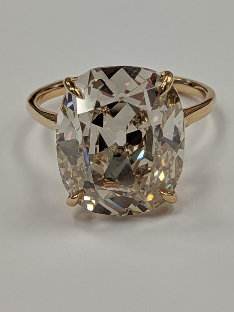 Unusual and collectible this gorgeous 9.09 carat Diamond has a Gubelin Report  grading this diamond as Fancy Light Pinkish Orange type IIA.  We grade it as 