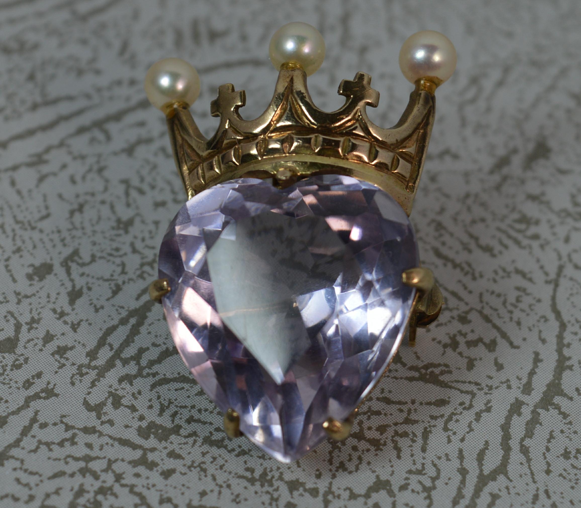 A fantastic solid 9 carat yellow gold brooch. Georgian or Victorian design, vintage piece. 
Designed with a heart cut pale amethyst to below. Above is a gold crown set with three pearls.
Condition ; Very good. Working pin and hinge. Crisp design.