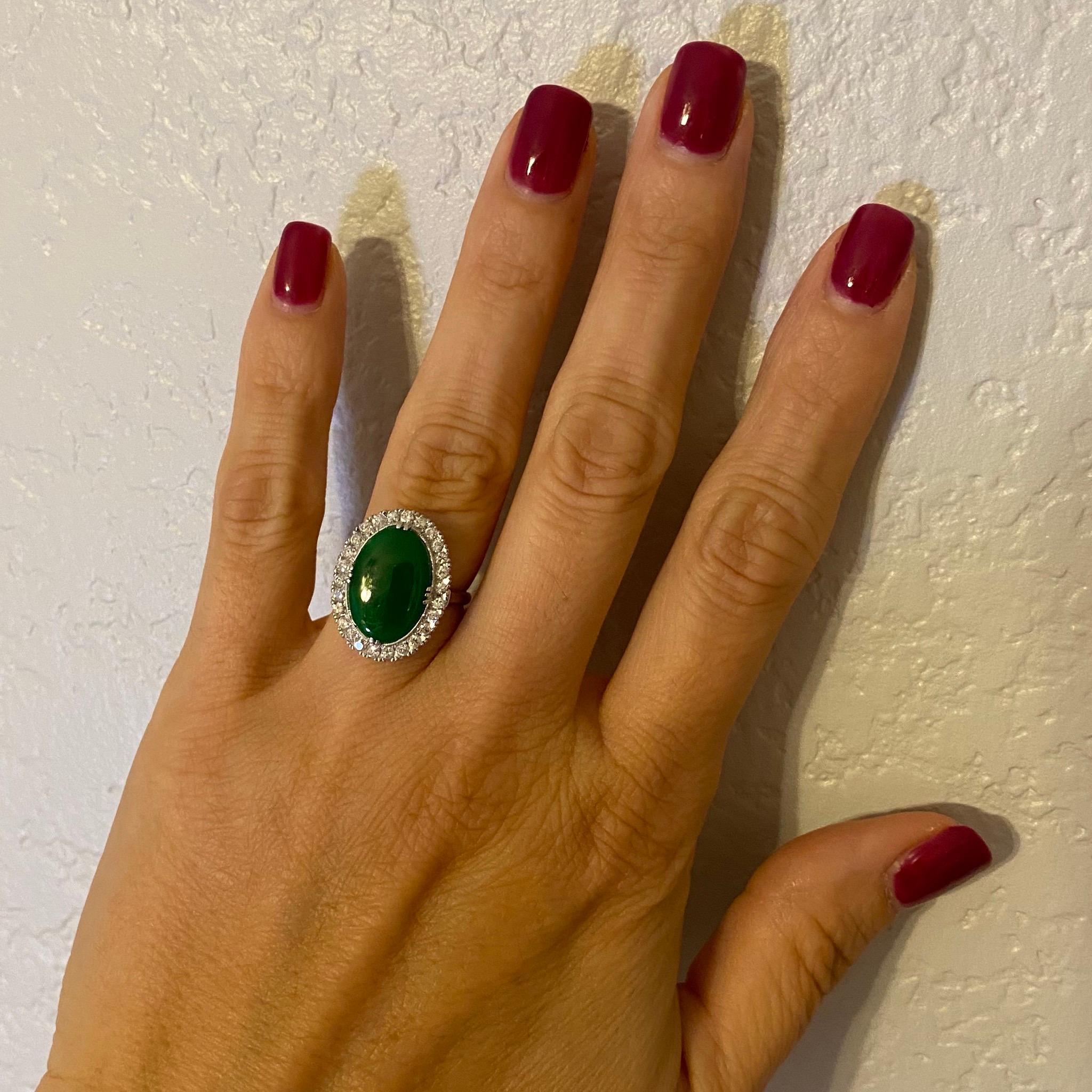 Simply Beautiful finely detailed Art Deco Cocktail Ring, center set with a securely nestled 9 Carat oval Jade surrounded by 26 Diamonds, weighing approx. 0.80 total Carat weight. Hand crafted Platinum mounting. Approx. Dimensions: 21mm x 15.8mm face